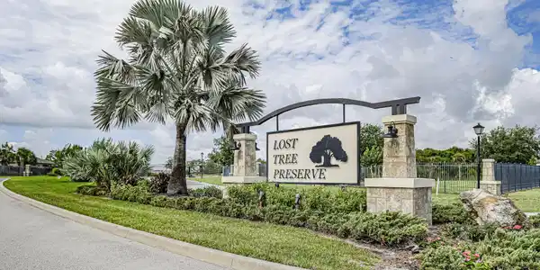Image 2: Community entrance featuring a prominent sign with