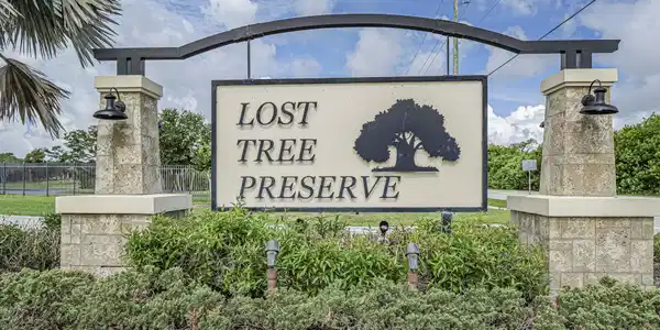 Image 3: Gated community entrance sign with stone-clad pill