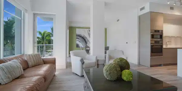 Image 2: Open living area overlooking the resort-style pool