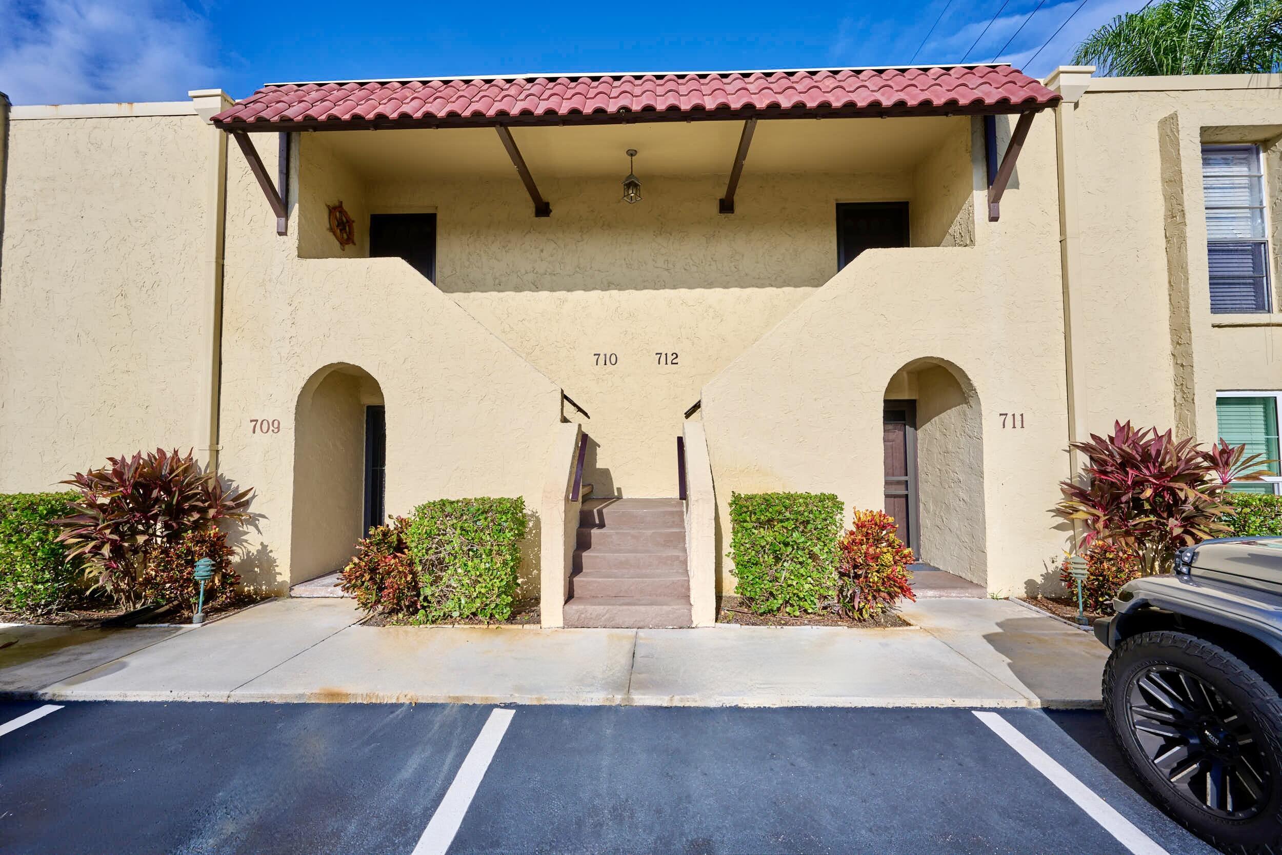 Image 4: View of building exterior and assigned parking 712