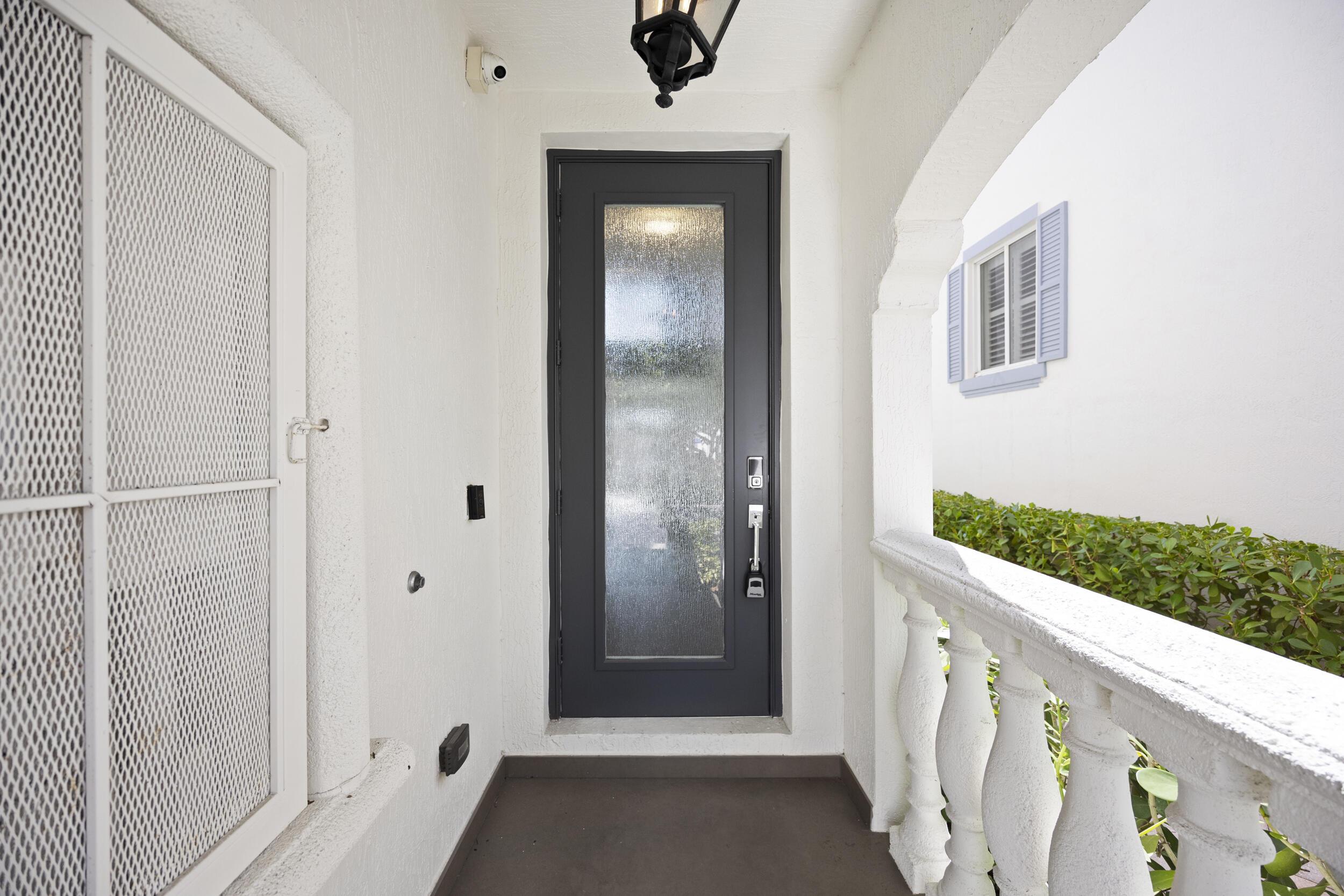 Image 3: Behind this elegant frosted impact glass door lies