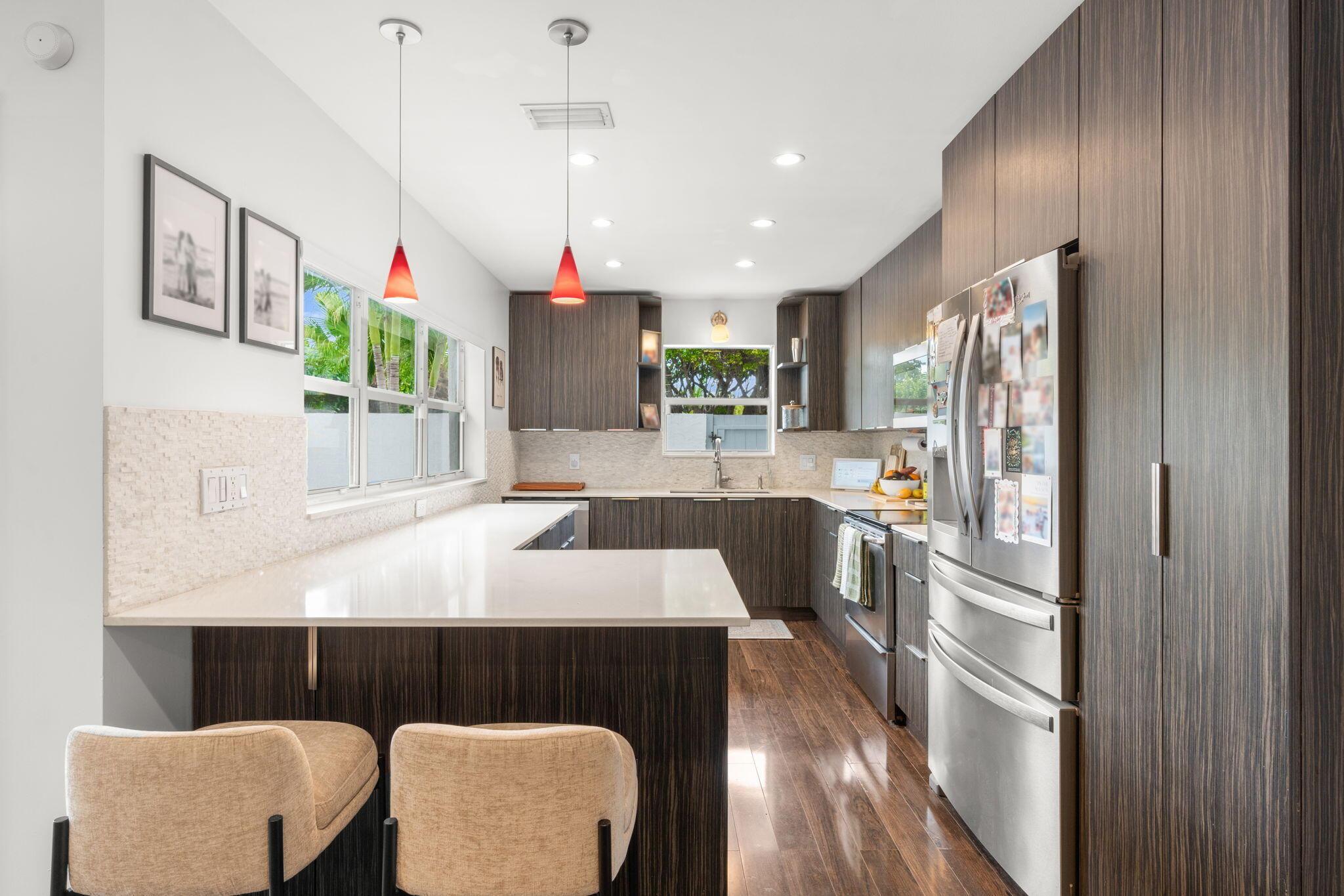 Image 2: Modern kitchen with peninsula seating, quartz coun