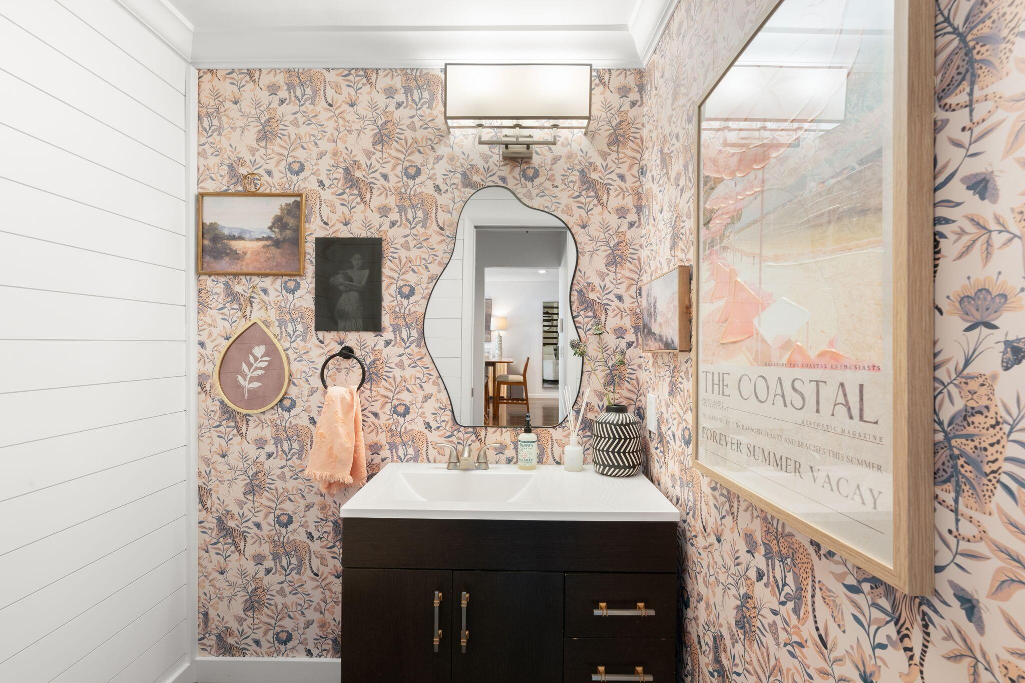 Image 4: Updated powder room featuring a modern vanity, dec