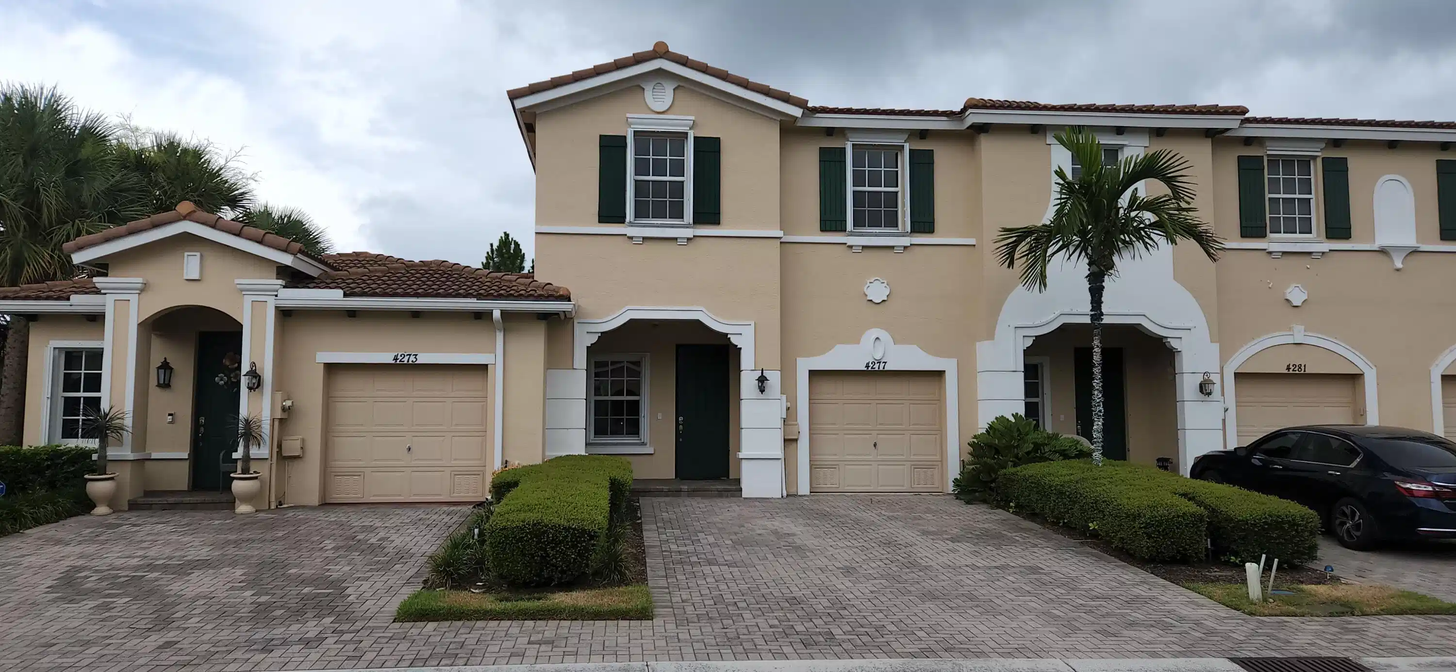 Image 1: Front with 1 car garage and parking for 2 cars