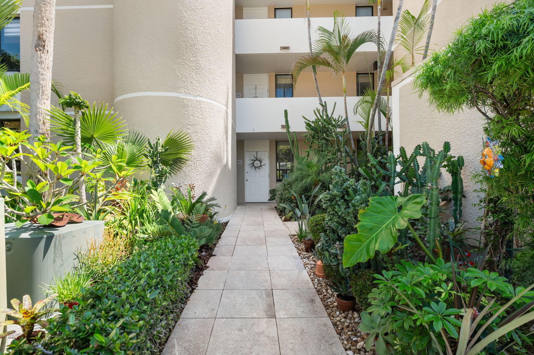 Image 2: Lush, tropical landscaping greets you as you enter