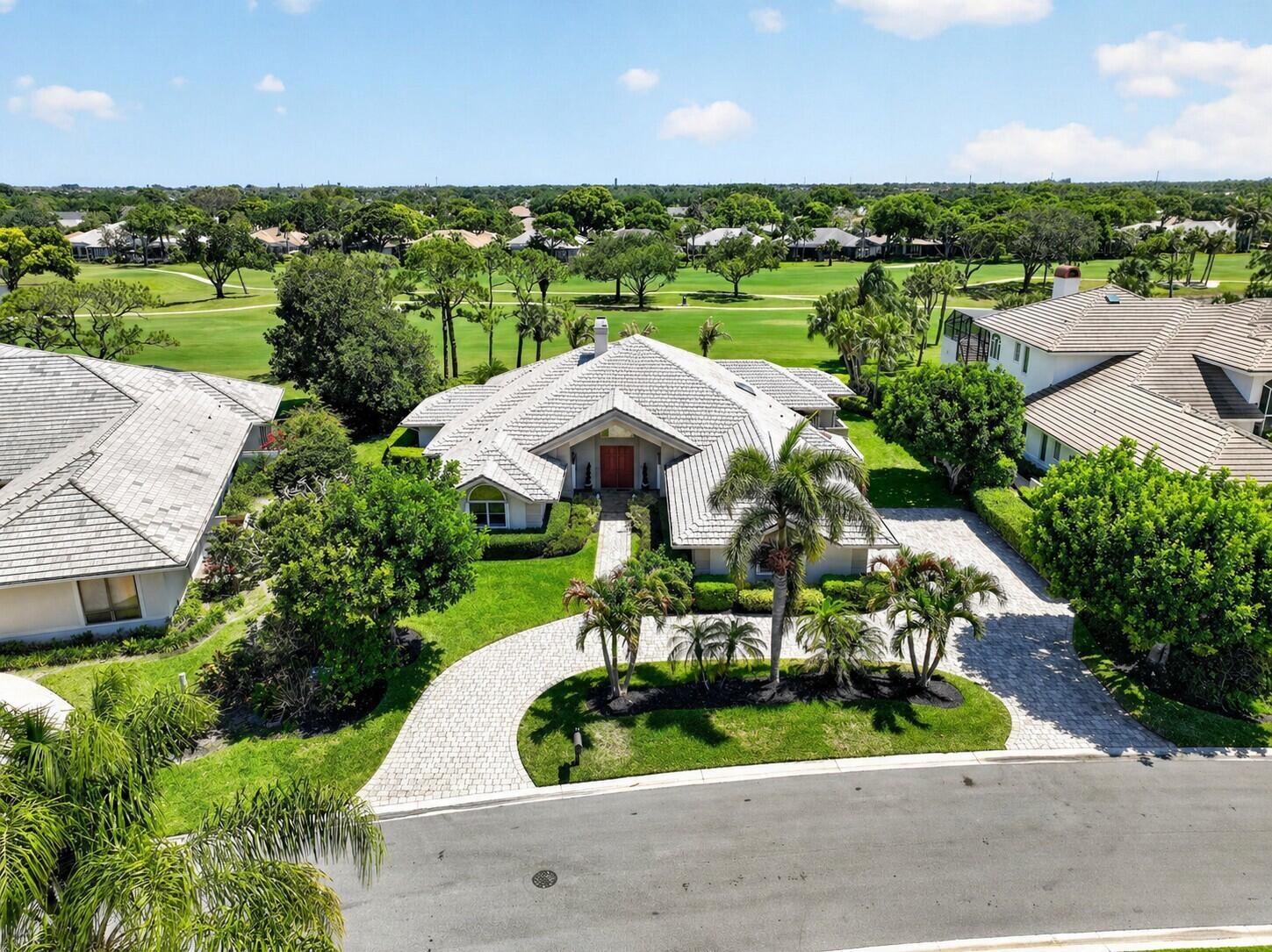 Image 4: Front with driveway and golf course
