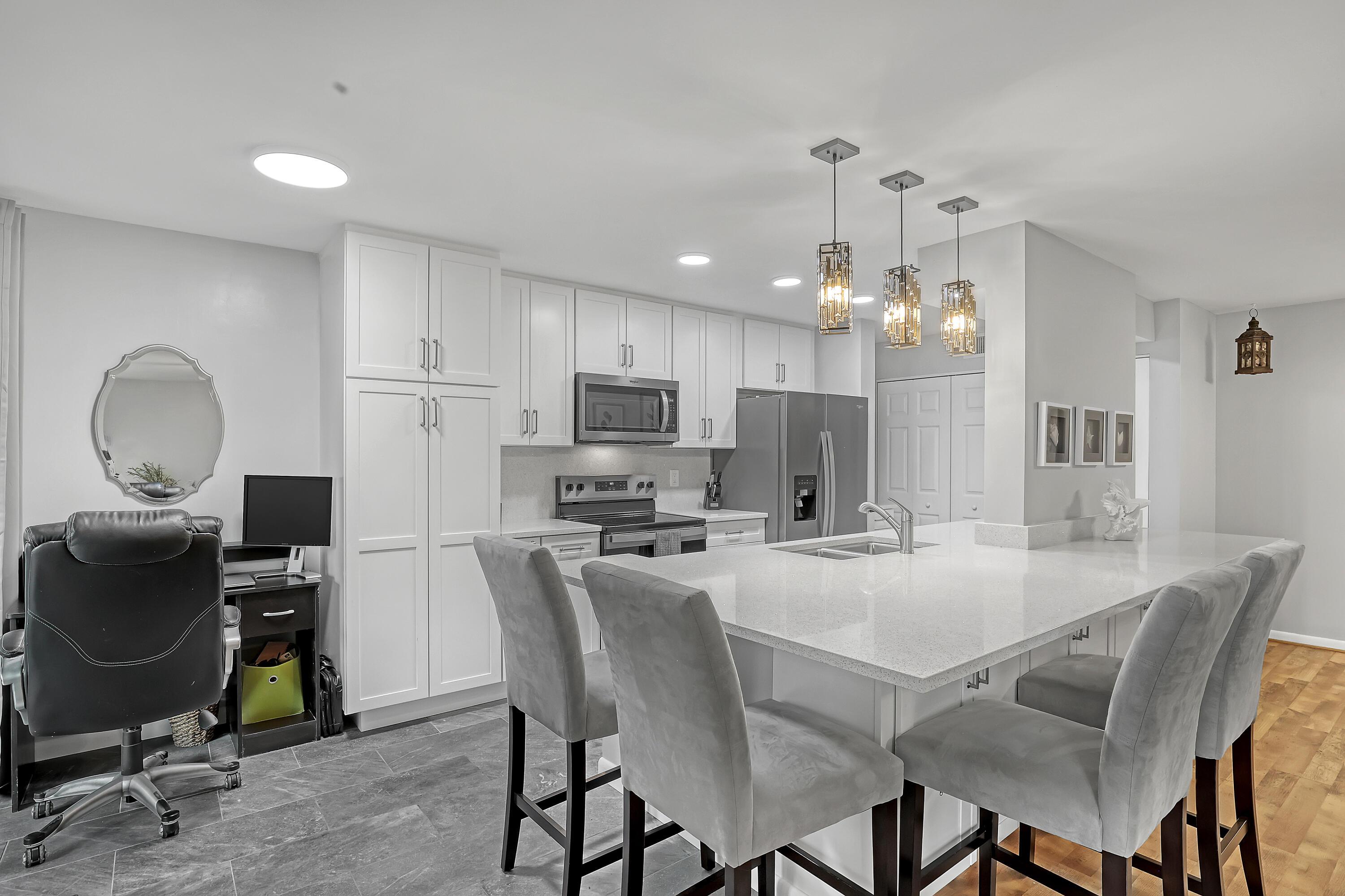 Image 3: A beautifully refreshed kitchen anchors the living