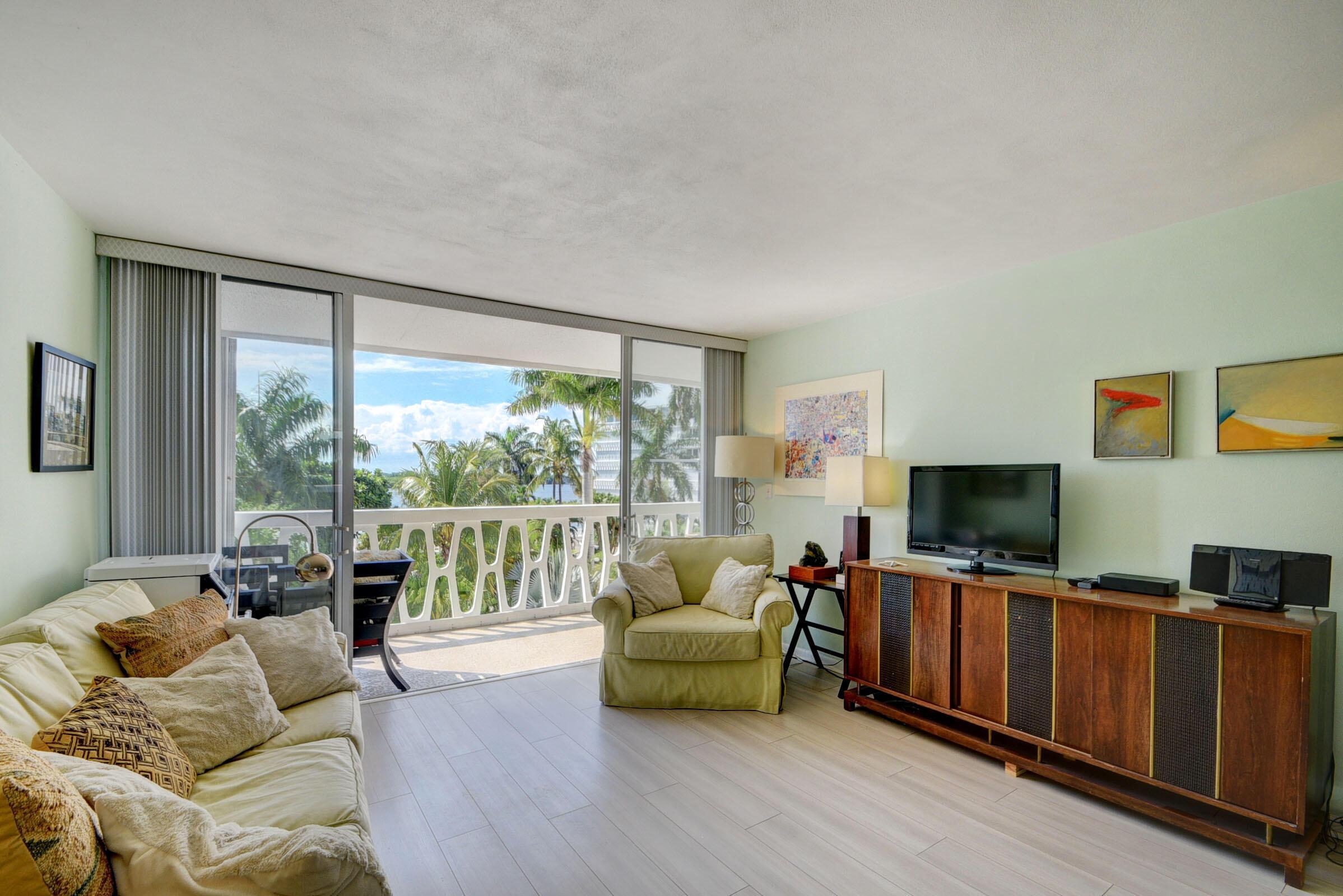 Image 2: Expansive living area featuring light wood-finish