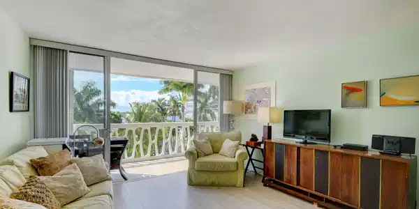 Image 2: Expansive living area featuring light wood-finish