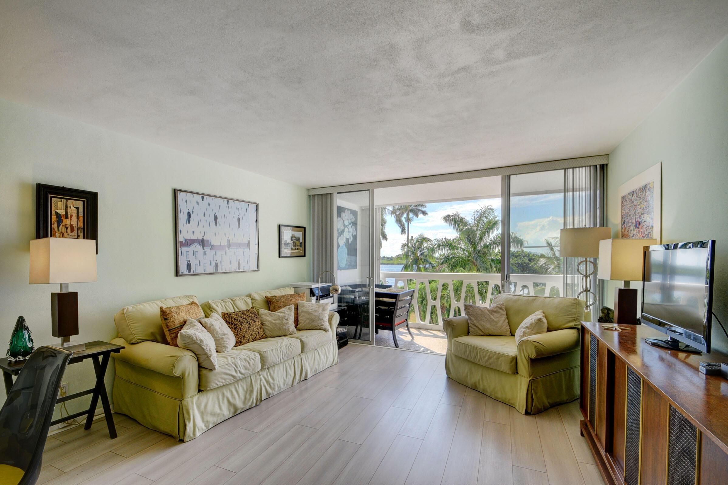Image 3: Spacious living area featuring light wood-finish f