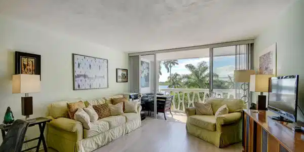Image 3: Spacious living area featuring light wood-finish f