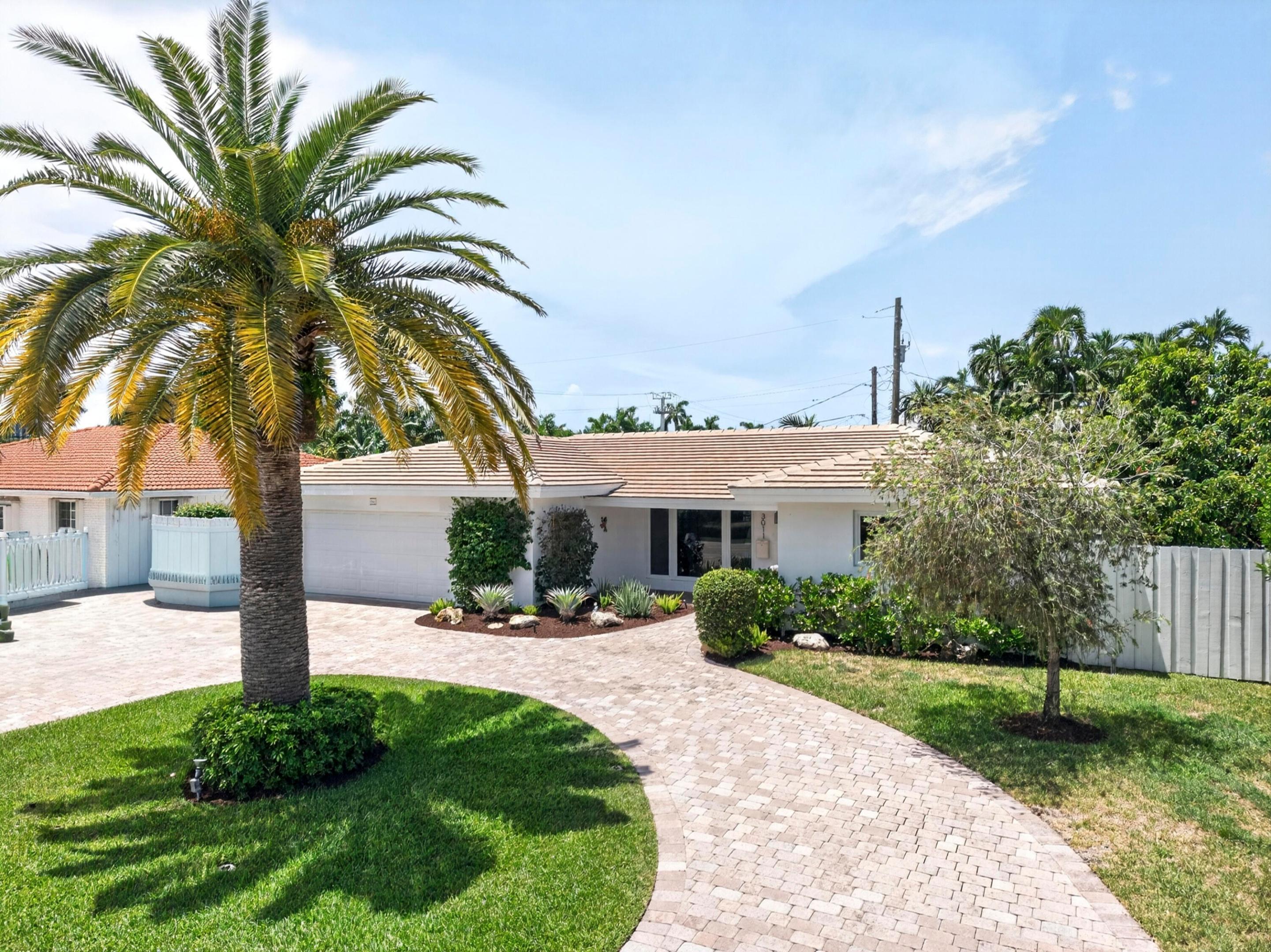 Image 1: Exterior residence featuring a paver driveway, mat