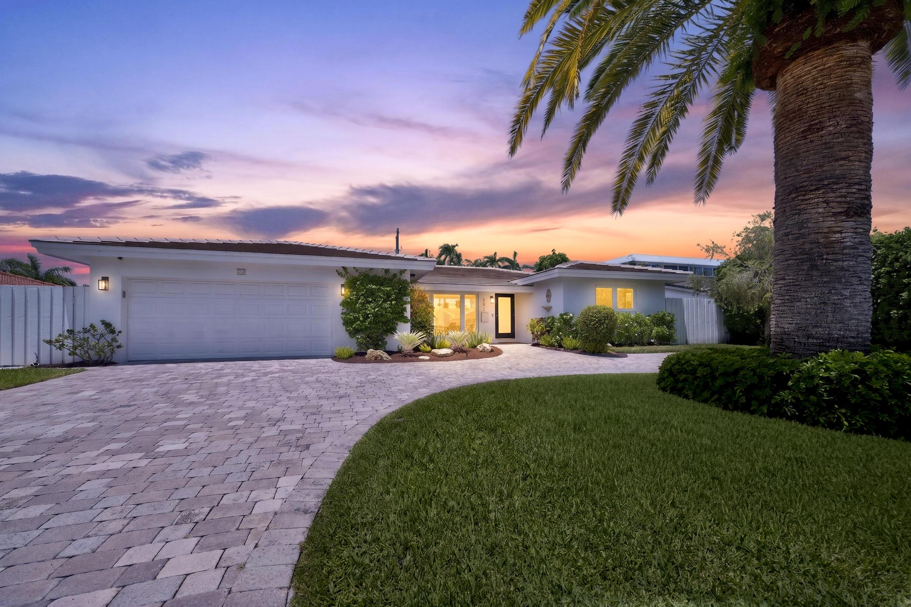Image 2: Contemporary single-story residence with a paver d