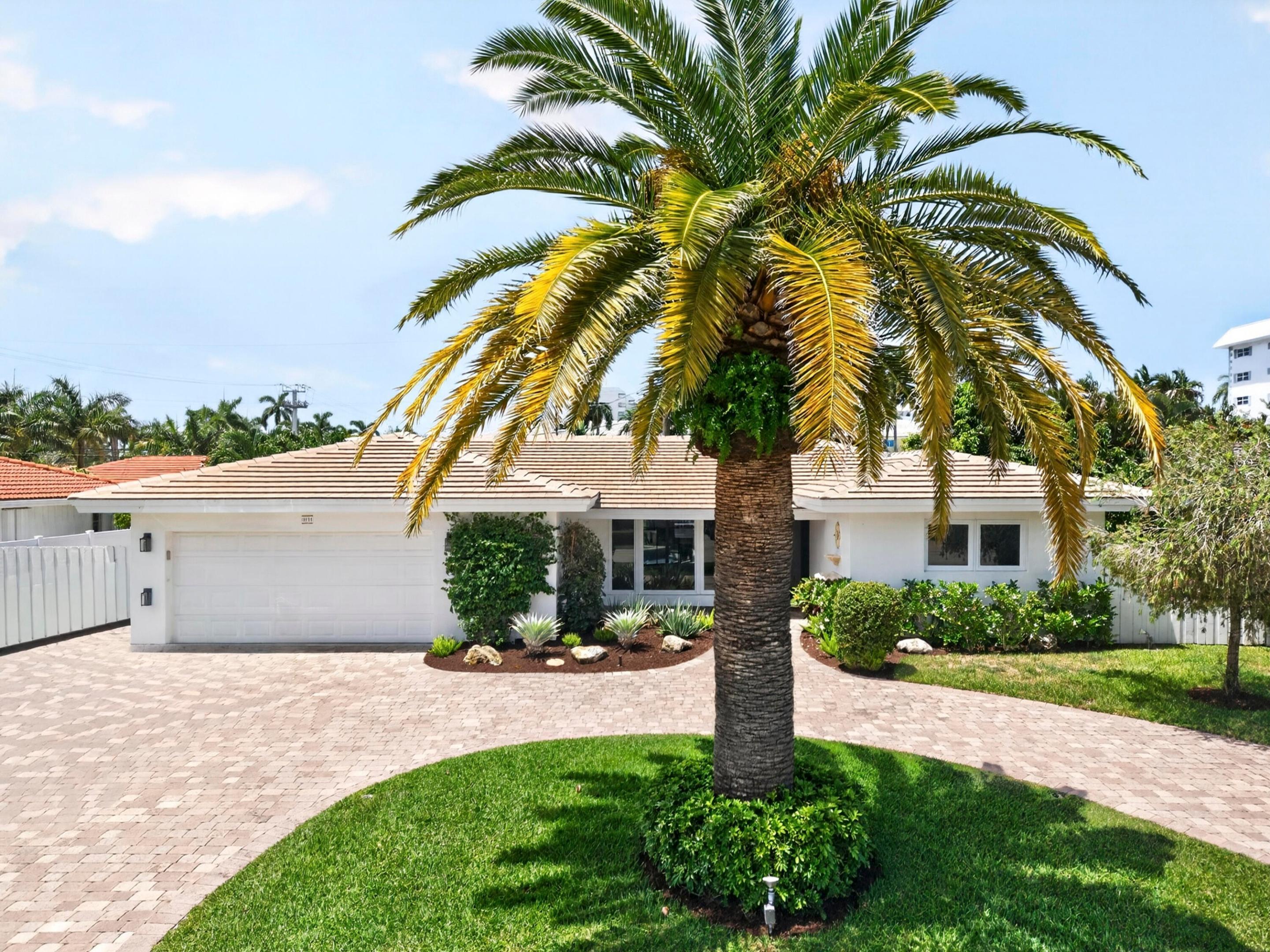 Image 3: White exterior residence featuring a tiled roof an