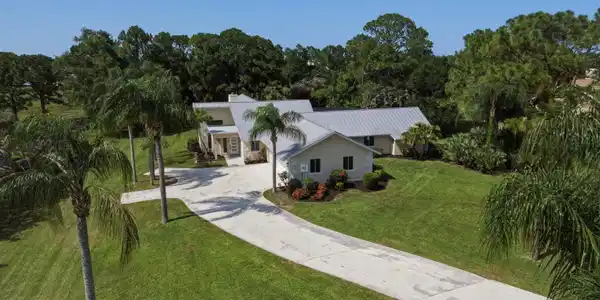 Image 2: Contemporary residence featuring a metal roof, a c