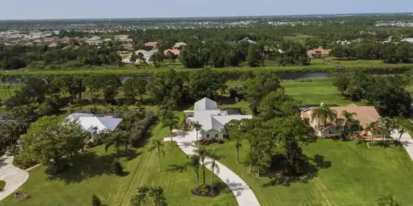 Image 3: Expansive property featuring a curving driveway, m