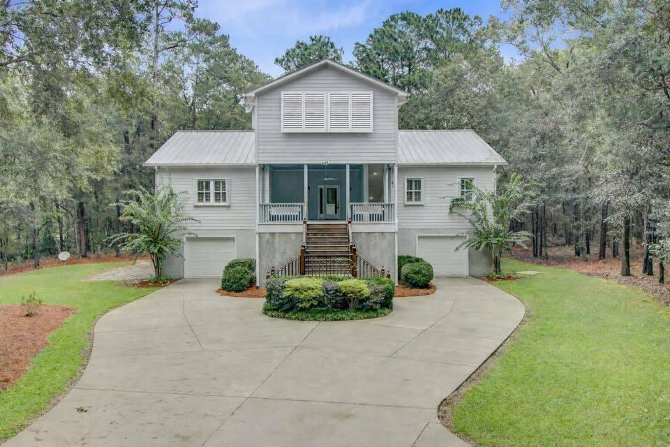 Image 1: Front with Bahama Shutters