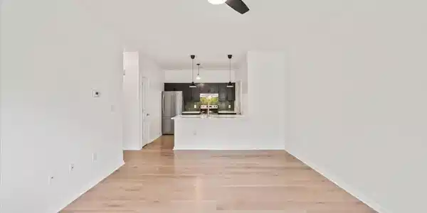 Image 2: Open floor plan. New wood floors.