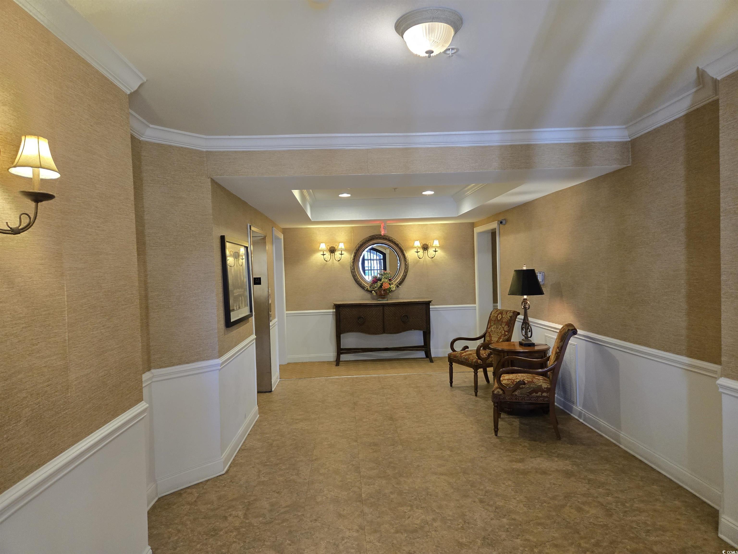 Image 3: Corridor with a raised ceiling, wainscoting, and o Image 3: Corridor with a raised ceiling, wainscoting, and o