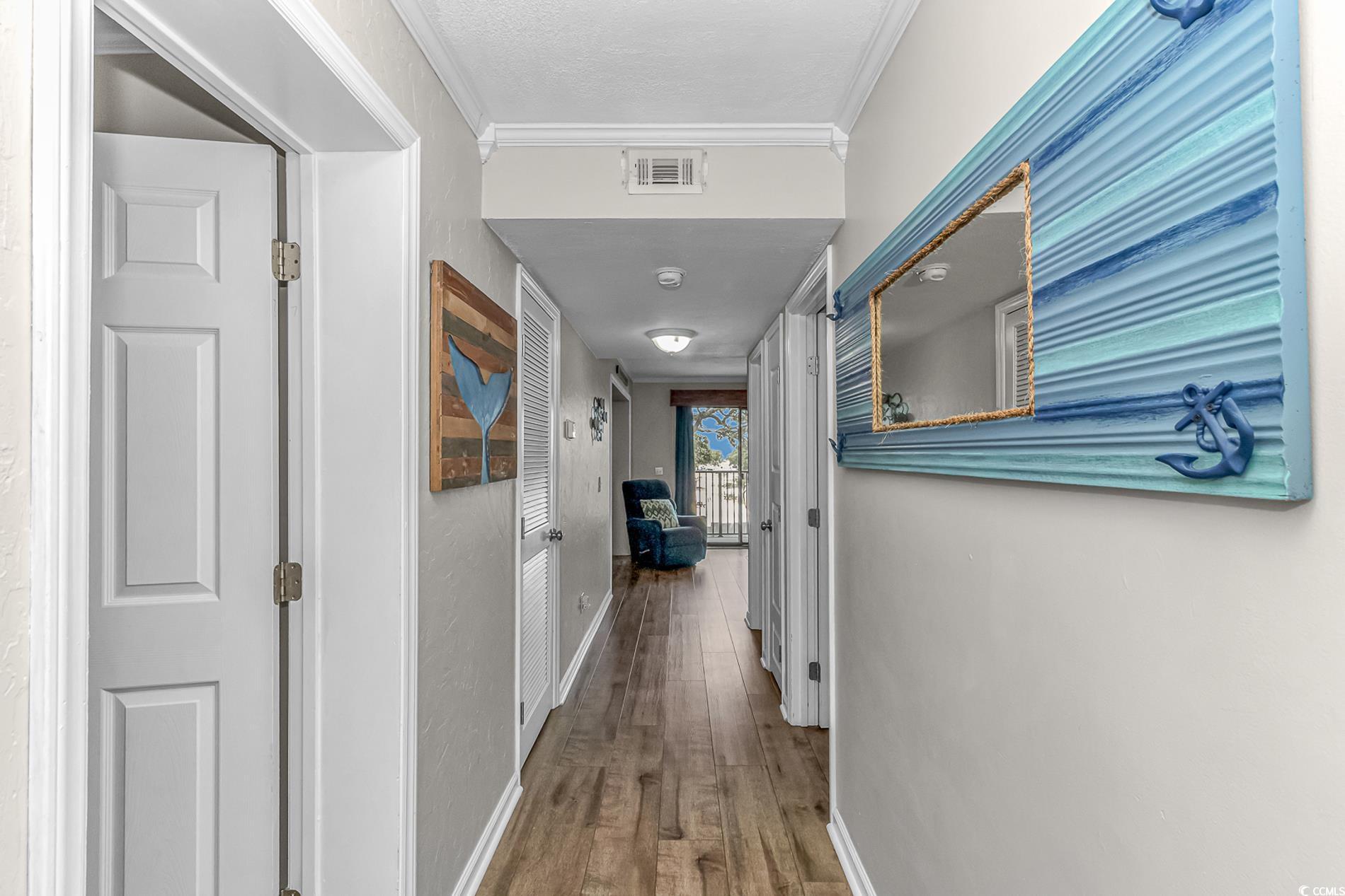 Image 2: Hallway featuring ornamental molding, wood finishe