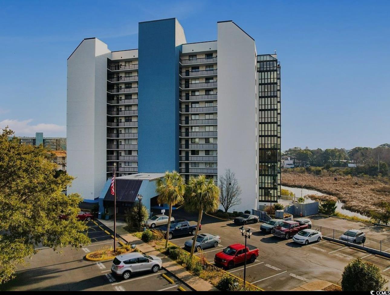 Image 1: View of building exterior featuring uncovered park Image 1: View of building exterior featuring uncovered park