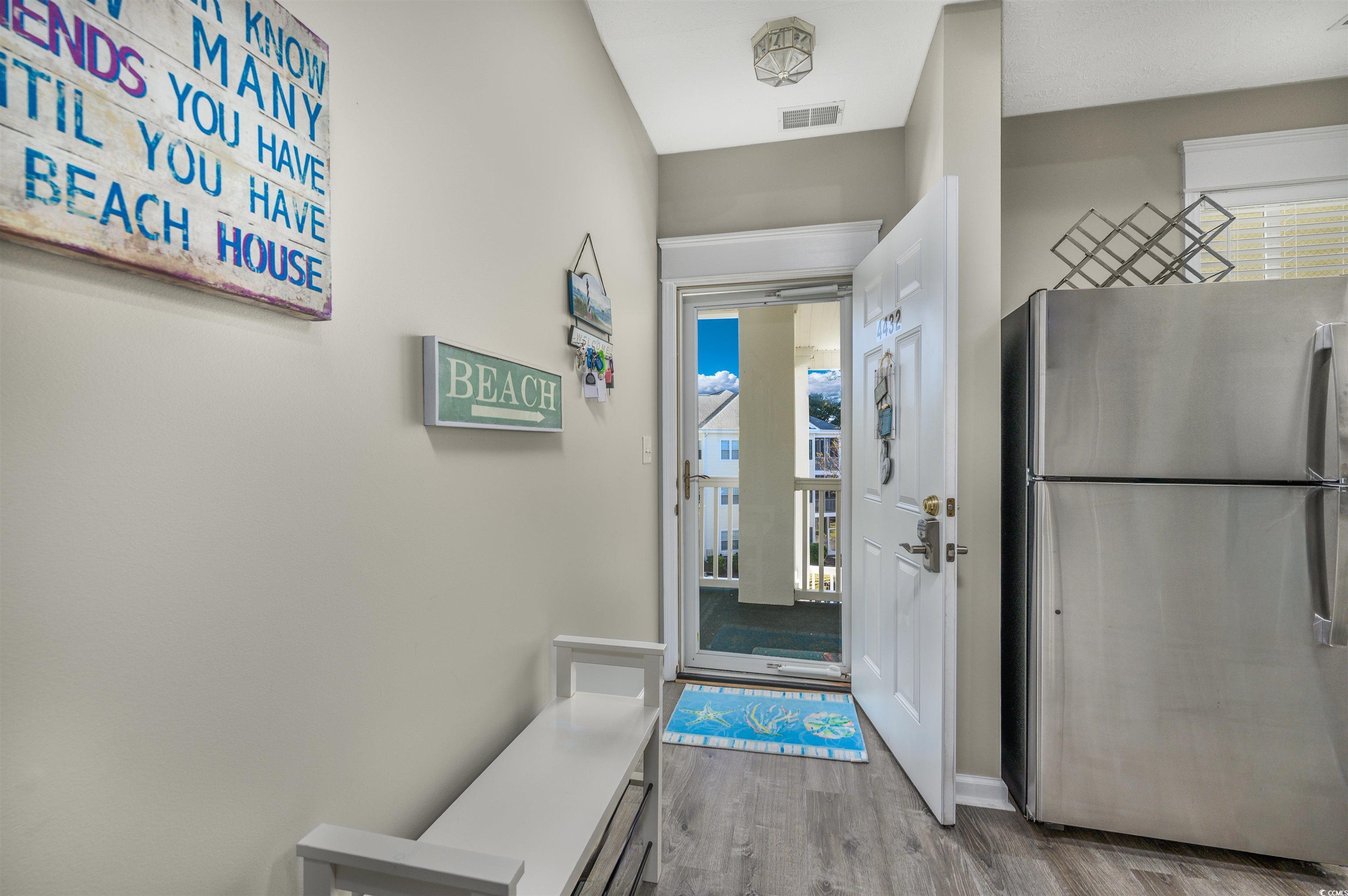 Image 3: Doorway with wood finished floors and baseboards Image 3: Doorway with wood finished floors and baseboards