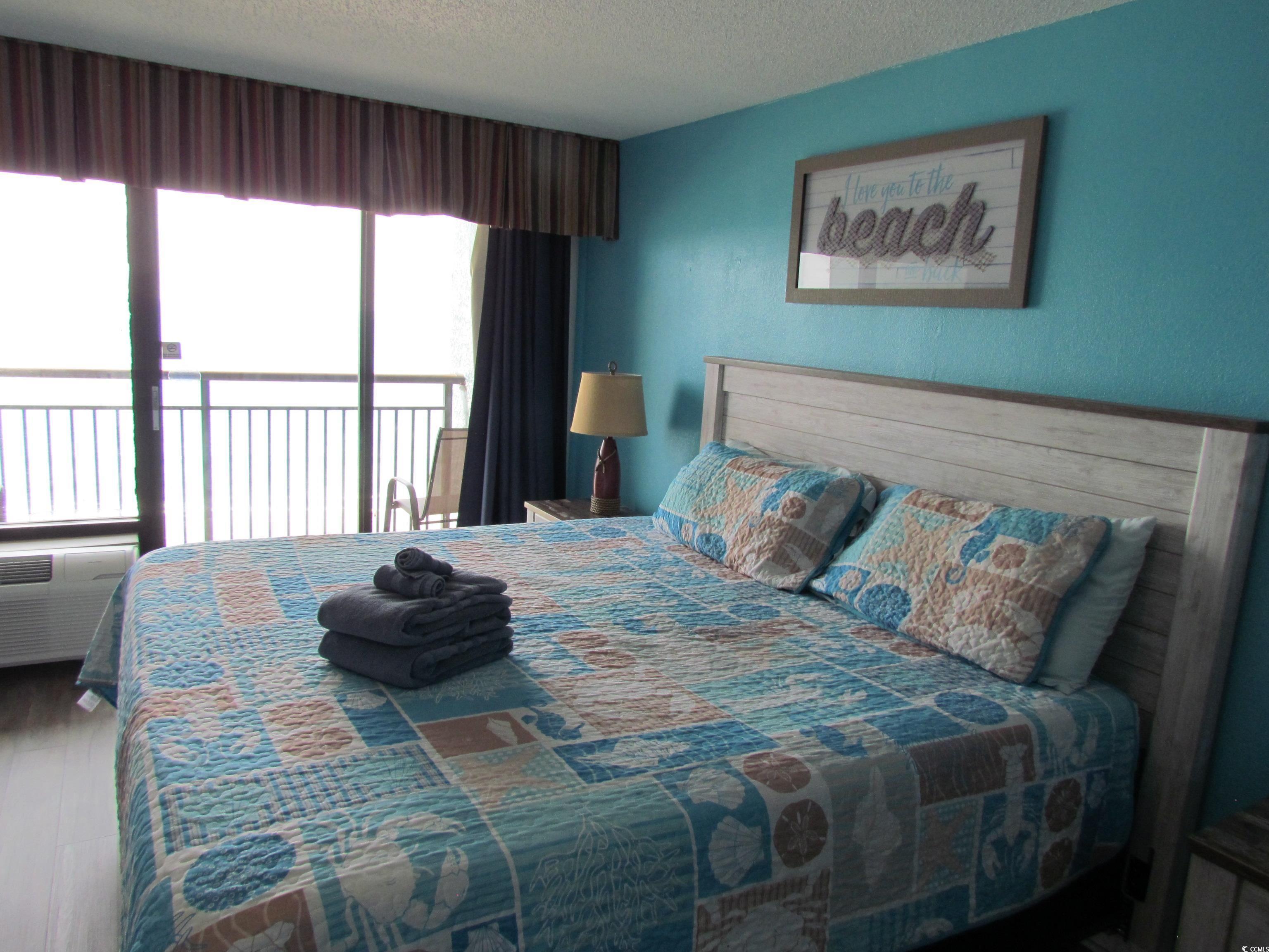 Image 4: Bedroom with a textured ceiling and access to outs Image 4: Bedroom with a textured ceiling and access to outs
