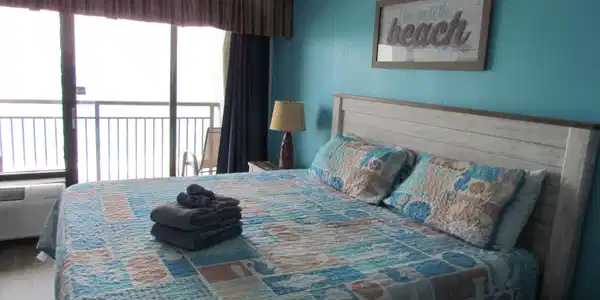 Image 4: Bedroom with a textured ceiling and access to outs