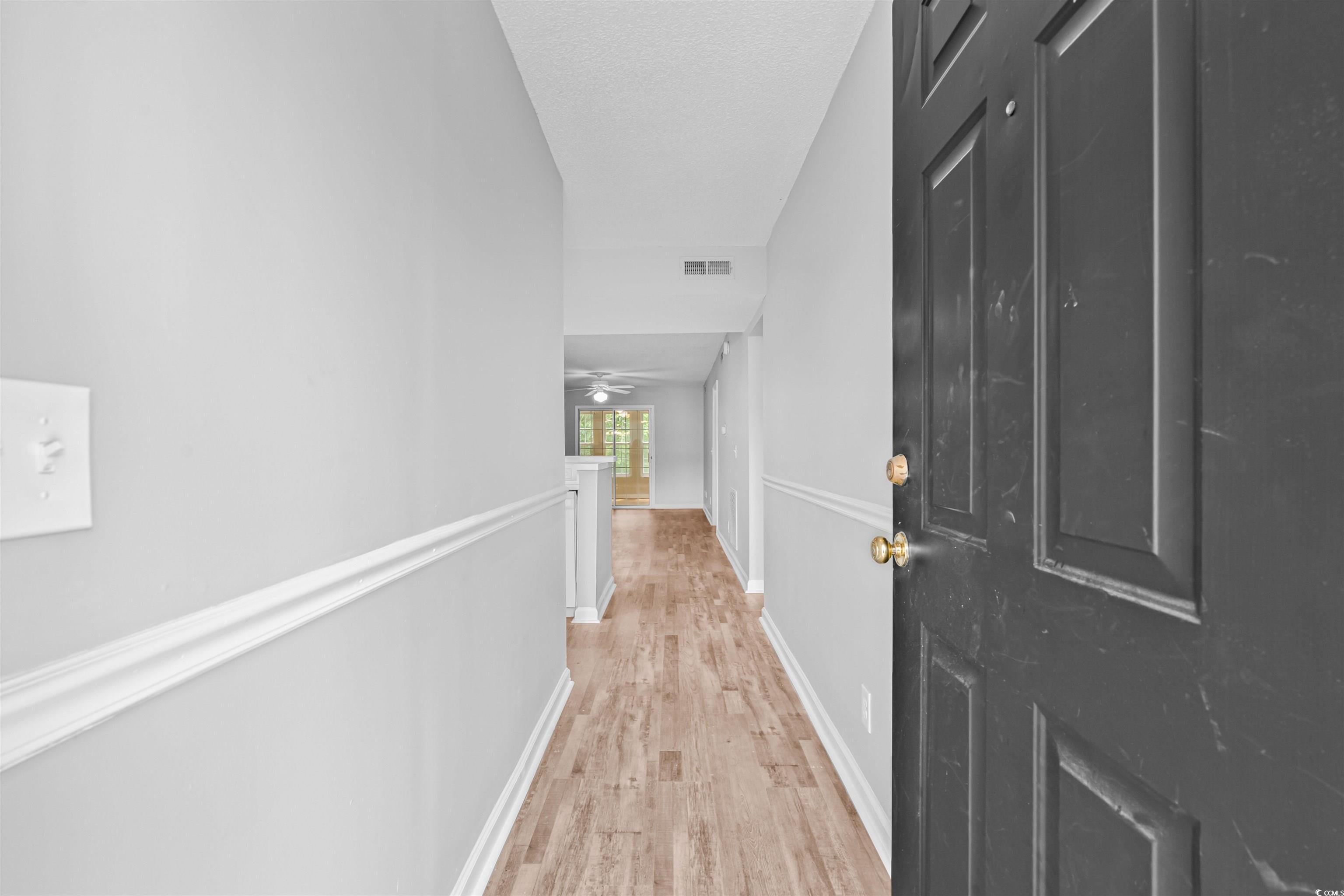 Image 4: Hallway featuring light wood-style flooring and an Image 4: Hallway featuring light wood-style flooring and an