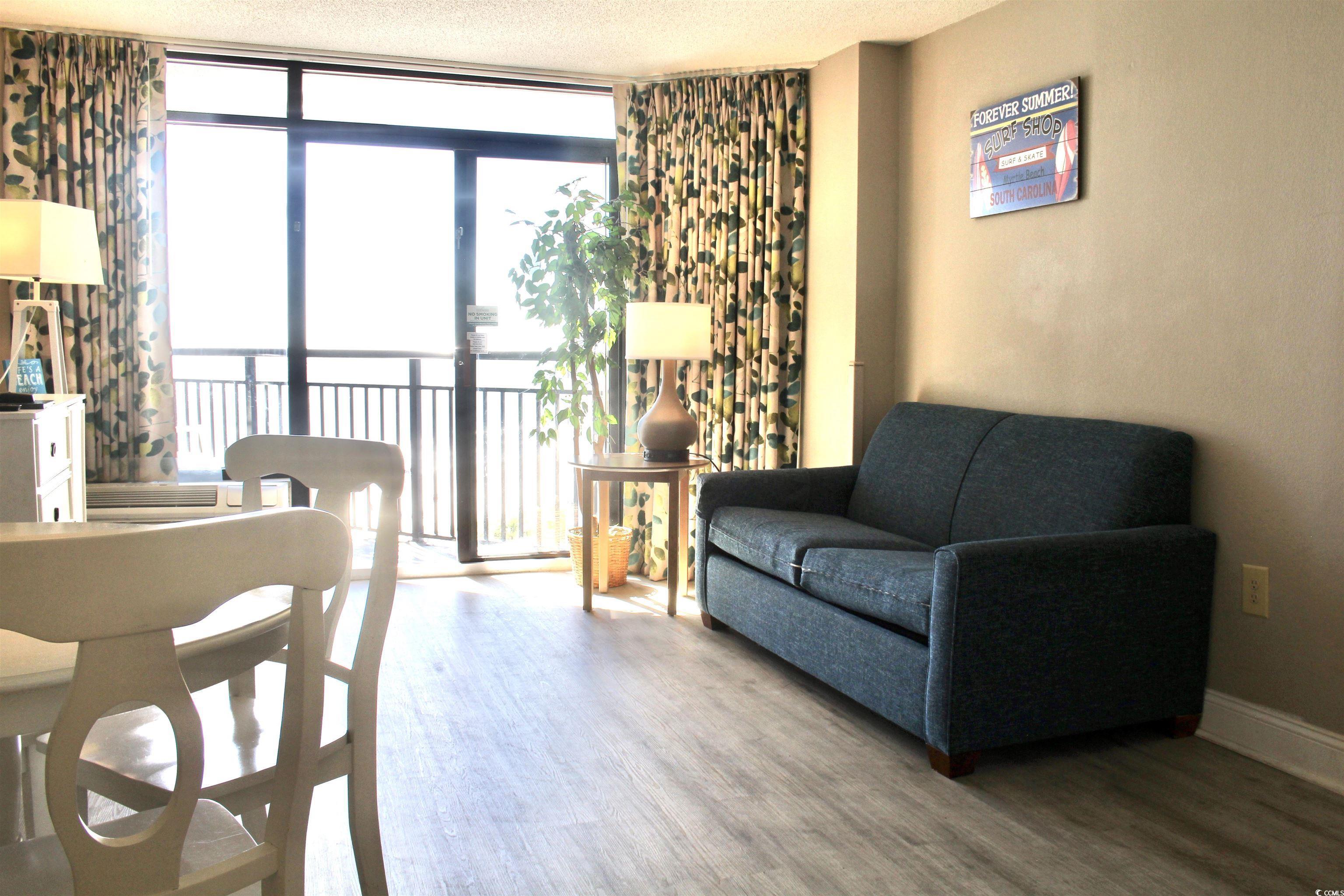 Image 2: Living area with expansive windows, wood finished Image 2: Living area with expansive windows, wood finished