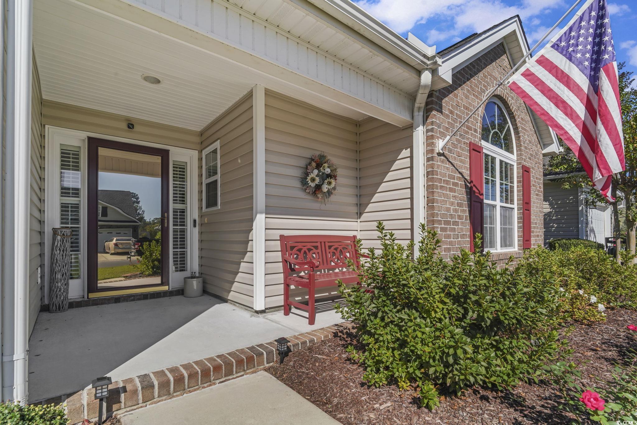 Image 2: Entrance to property featuring brick siding and a Image 2: Entrance to property featuring brick siding and a