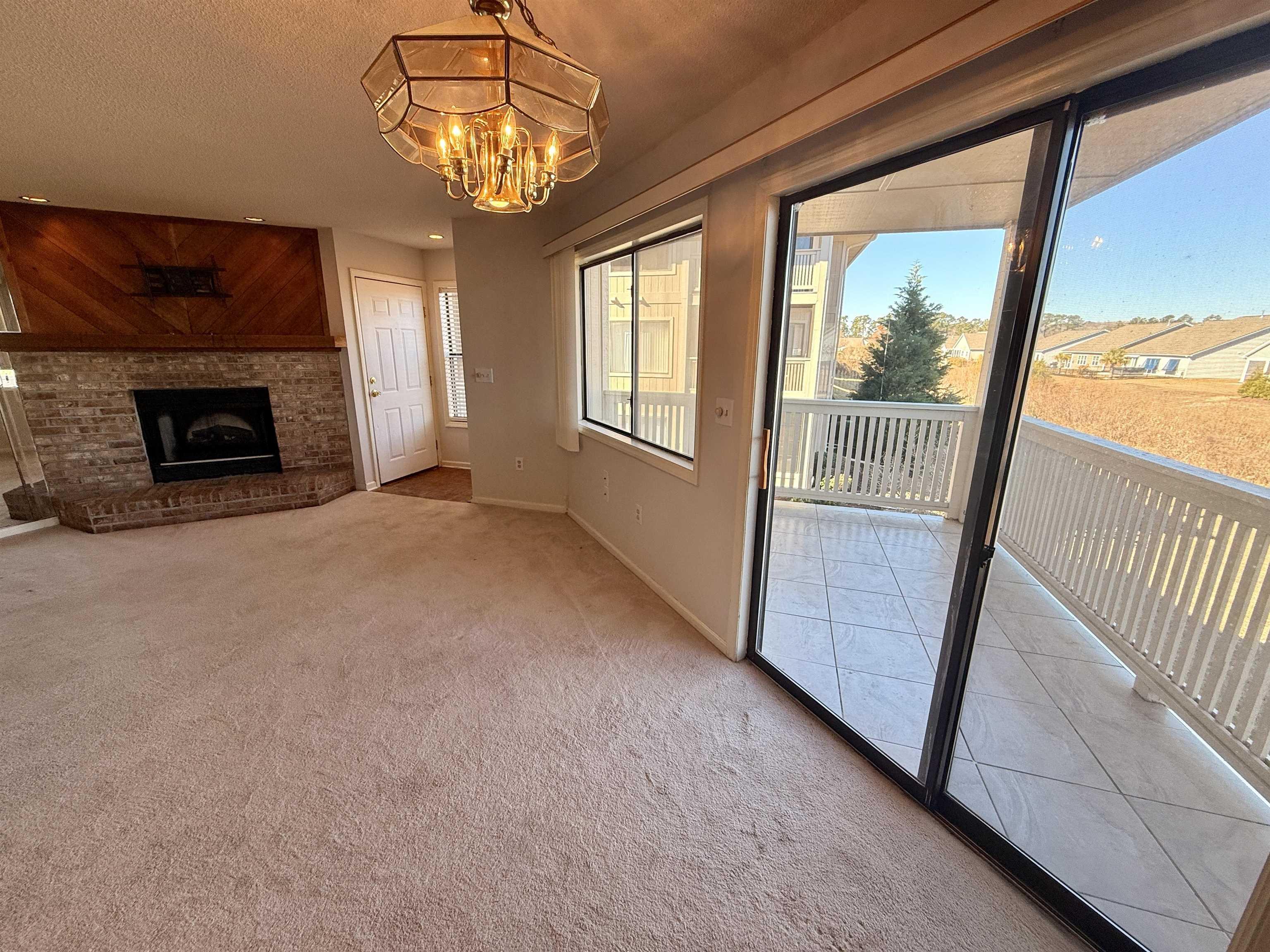 Image 4: Unfurnished living room with light carpet, a firep