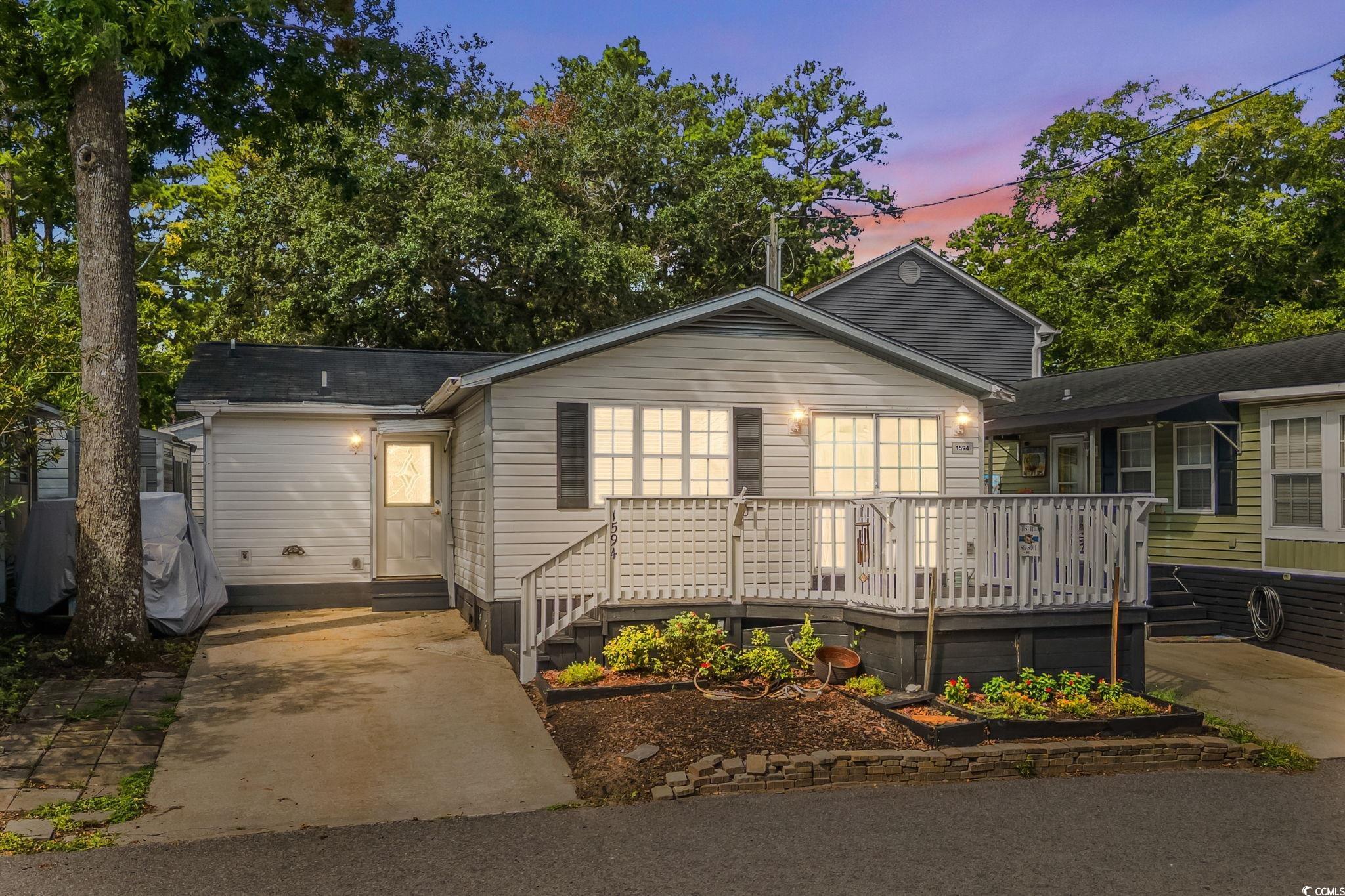 Image 1: View of front facade with a deck and entry steps Image 1: View of front facade with a deck and entry steps