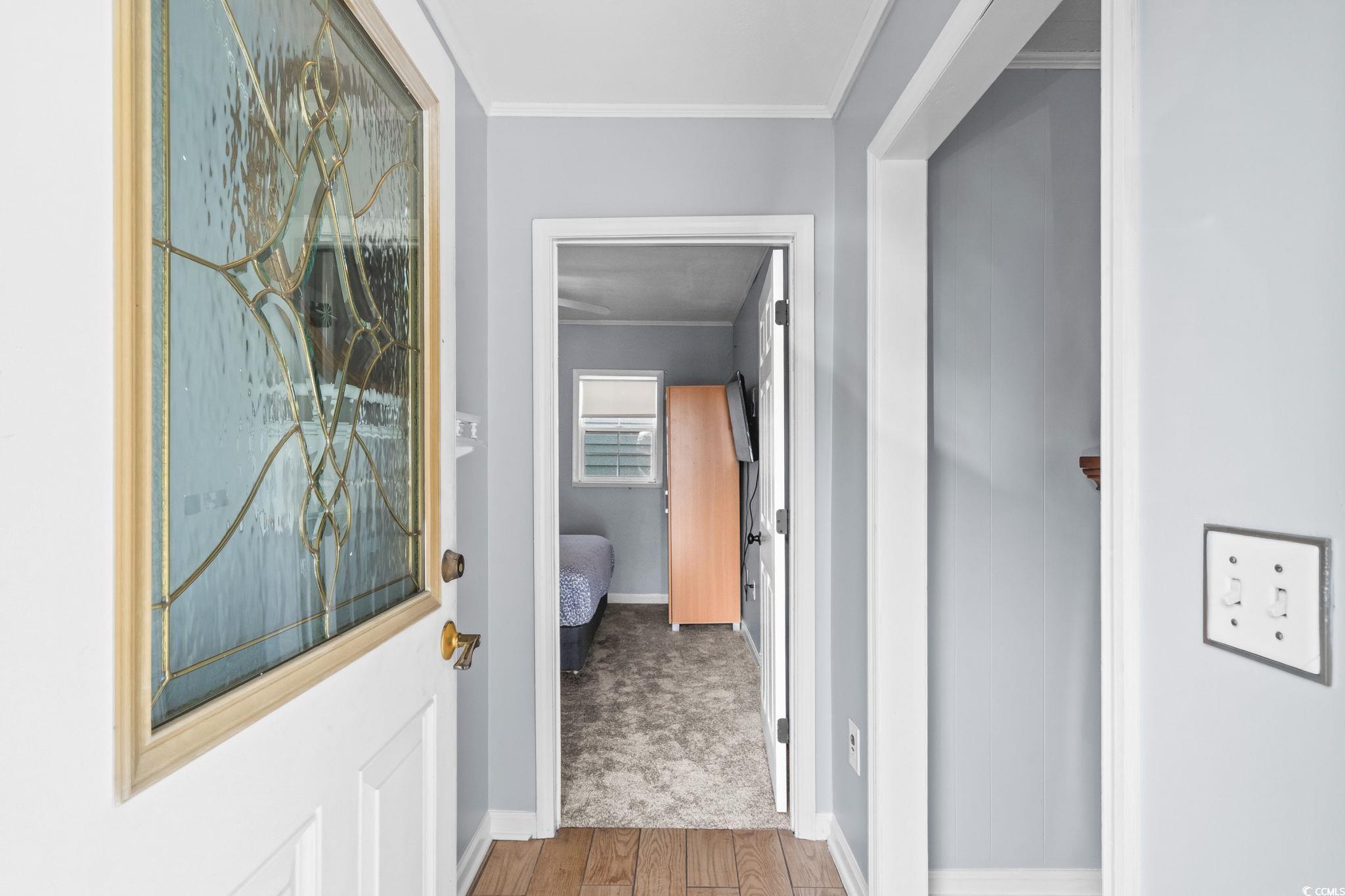 Image 3: Hallway with wood finished floors and crown moldin Image 3: Hallway with wood finished floors and crown moldin