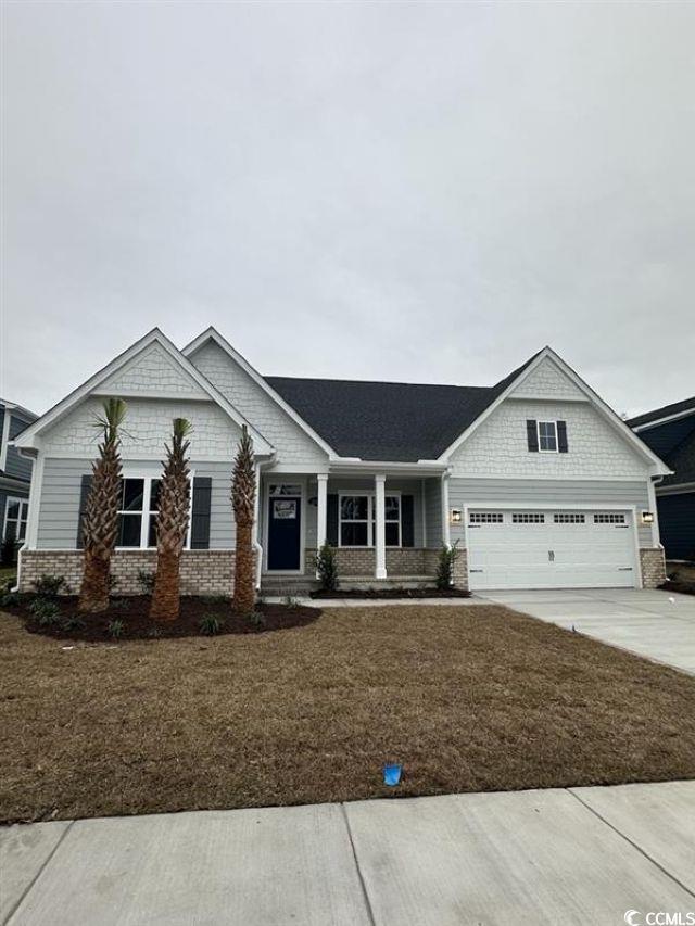 Image 1: Craftsman-style house with covered porch, driveway