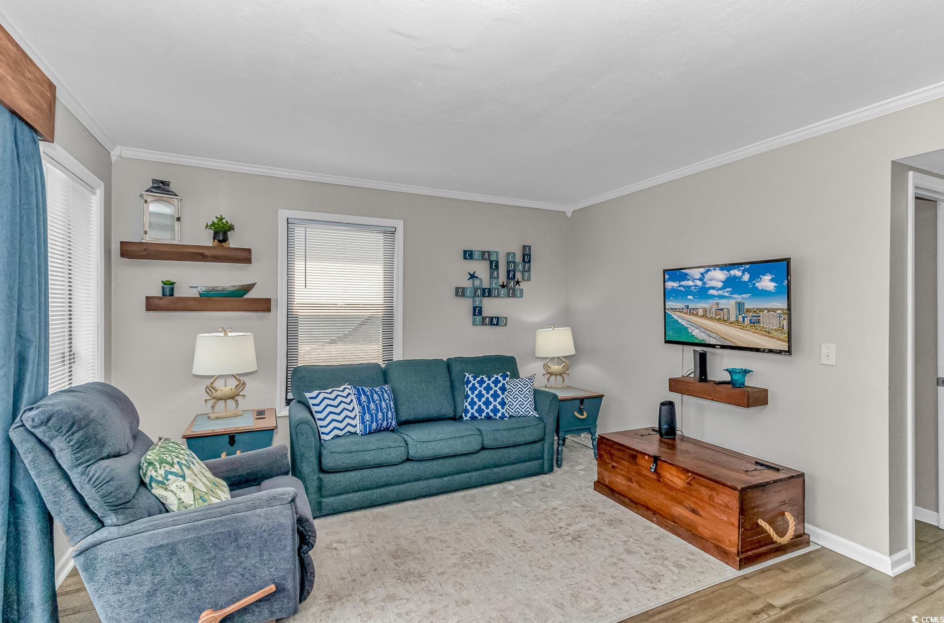 Image 4: Living room with wood finished floors and ornament