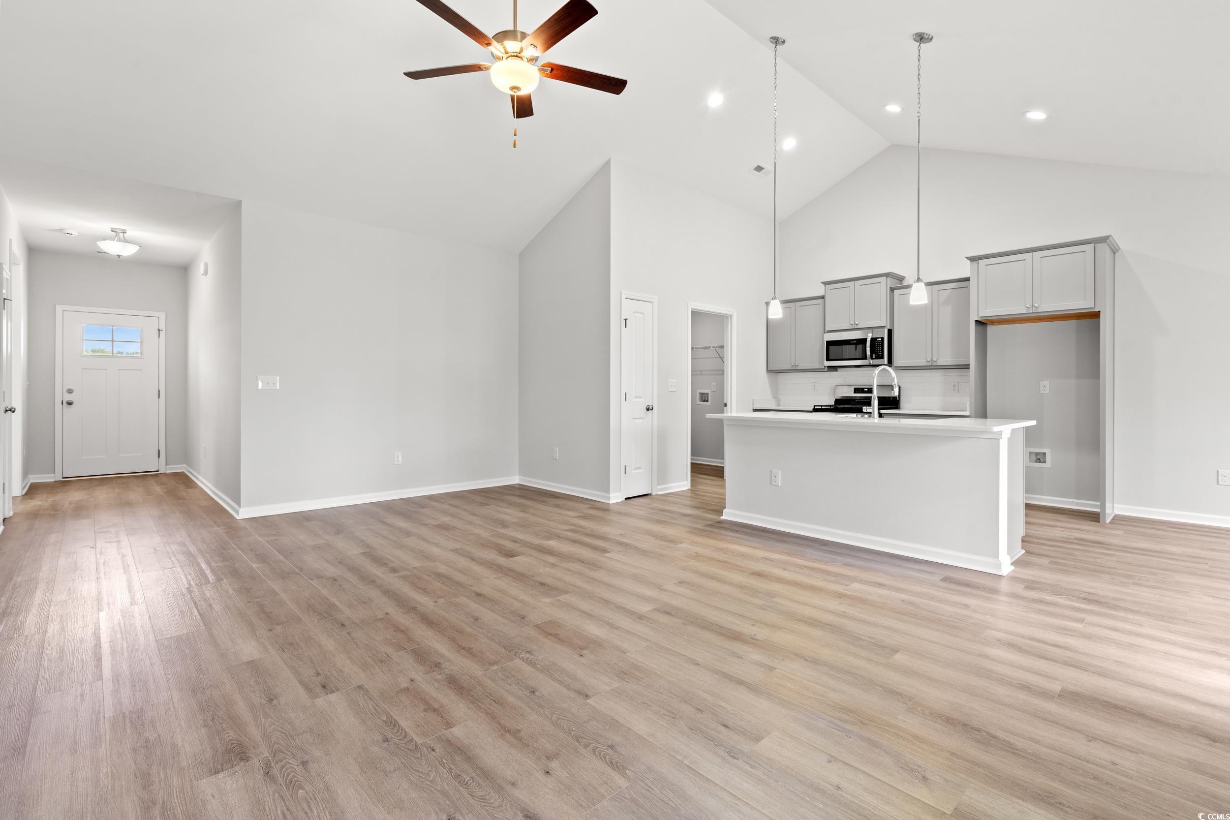 Image 2: Unfurnished living room with ceiling fan, light wo