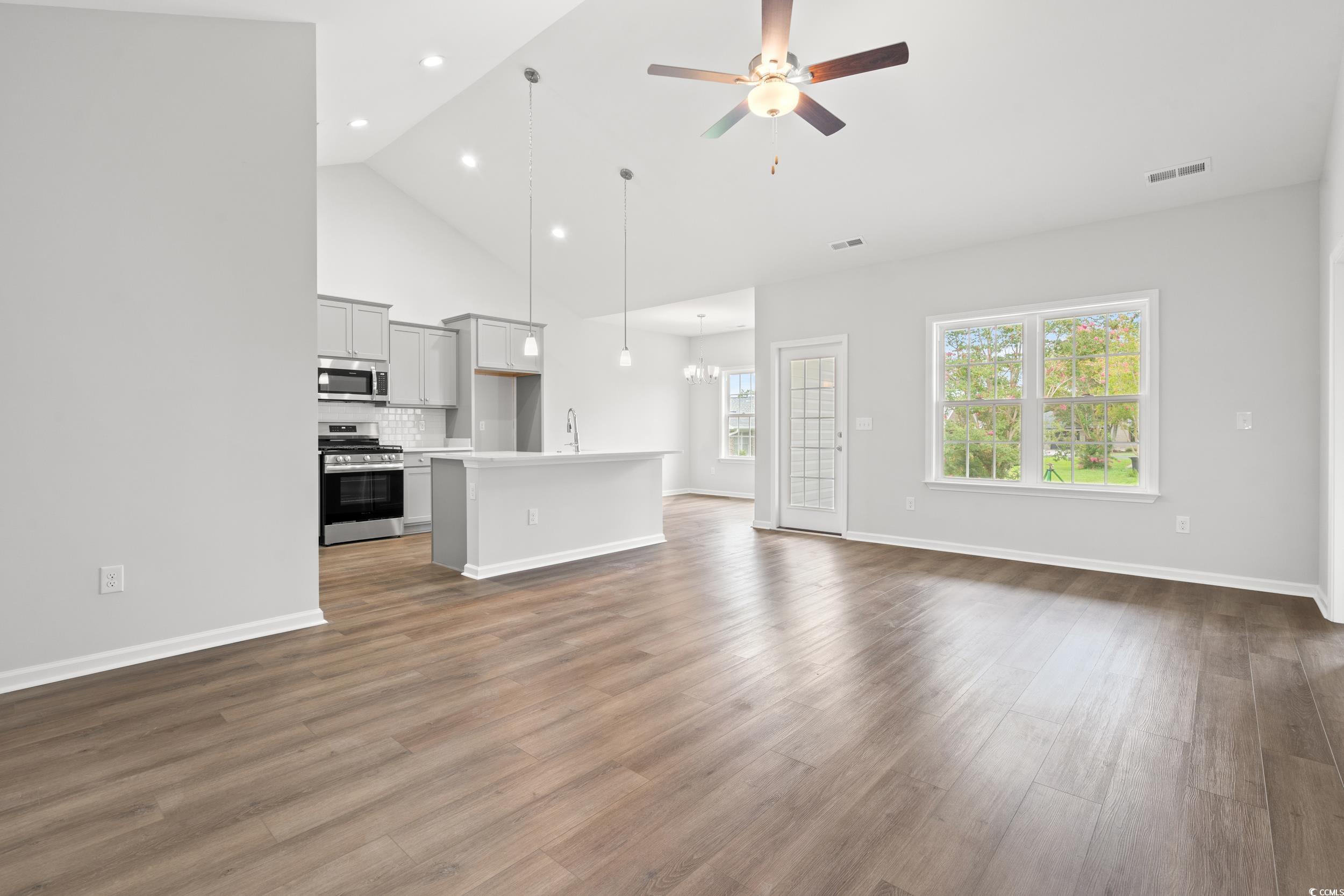 Image 3: Unfurnished living room featuring a ceiling fan, w