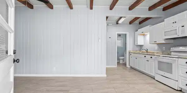 Image 4: Kitchen featuring white appliances, white cabinets