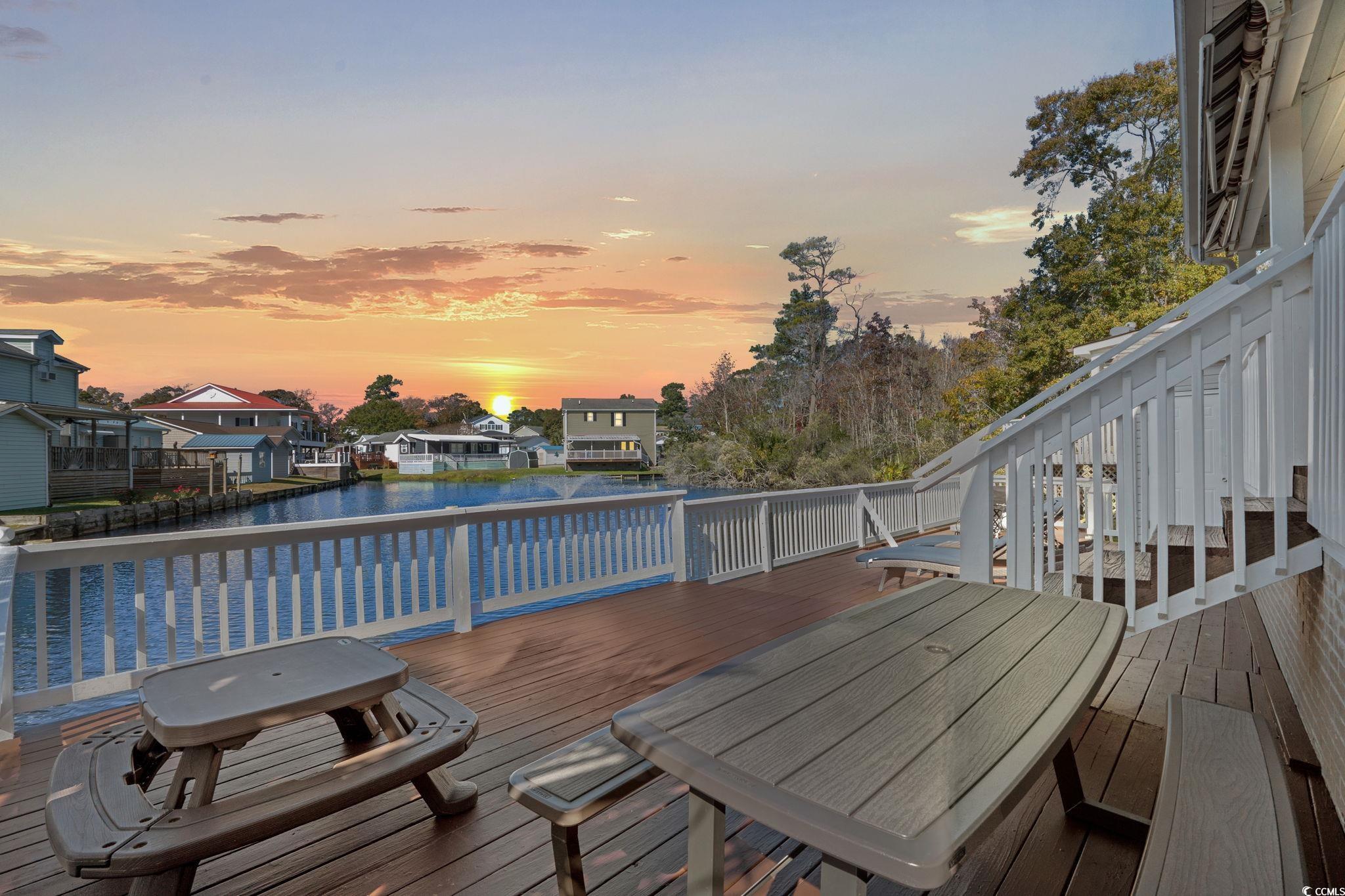 Image 2: Deck with outdoor dining area, a water view, and a Image 2: Deck with outdoor dining area, a water view, and a