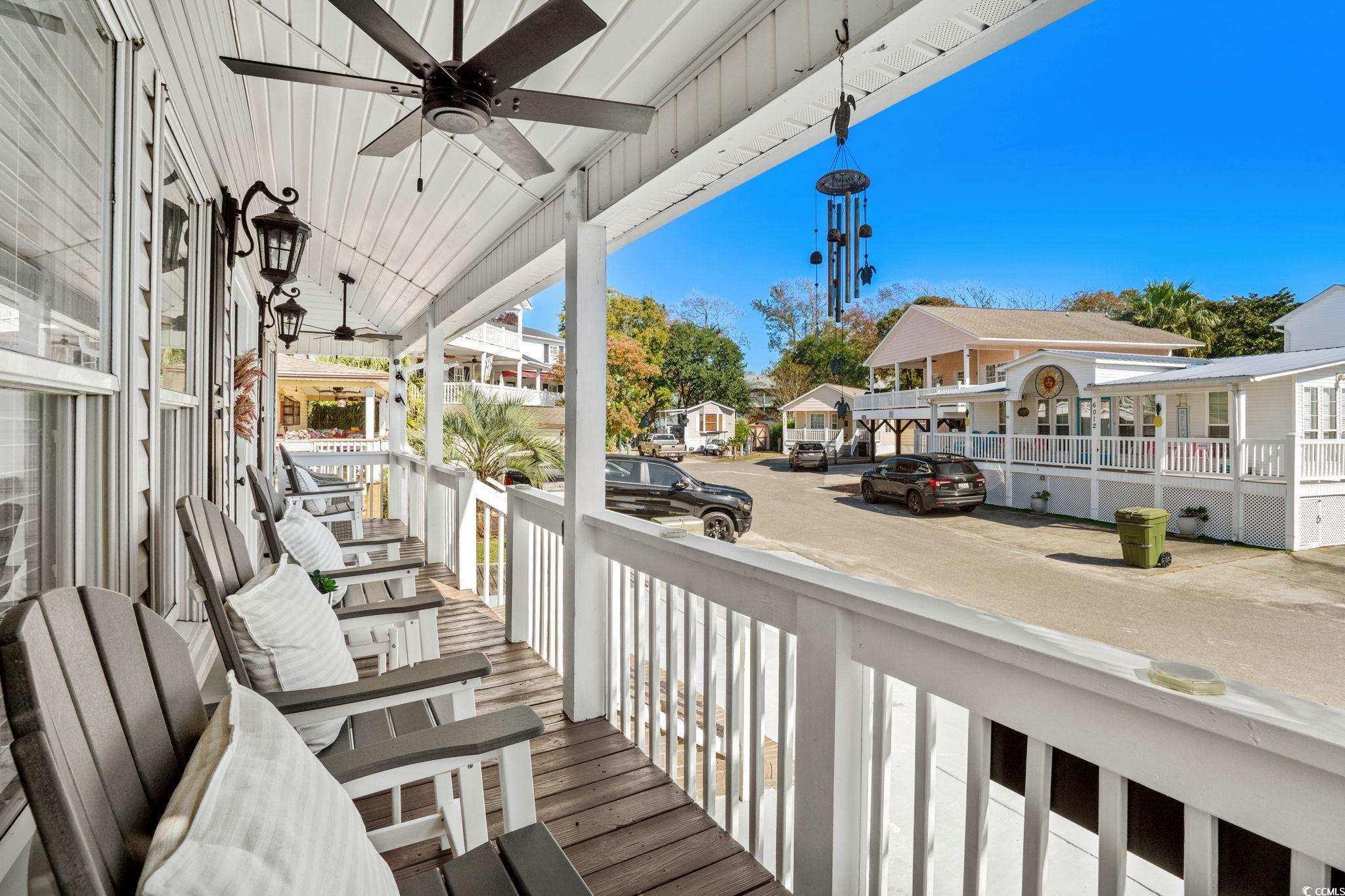 Image 4: Wooden porch with ceiling fan and a residential vi Image 4: Wooden porch with ceiling fan and a residential vi