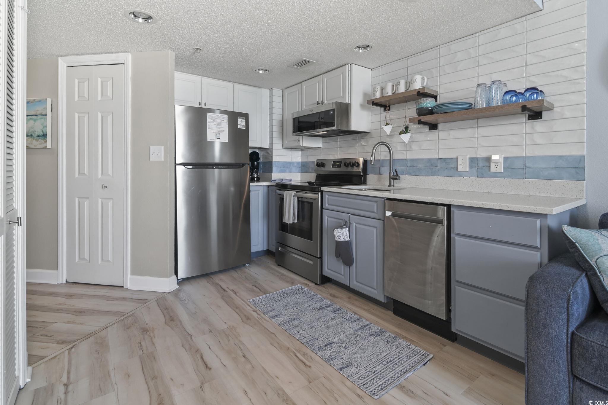 Image 3: Kitchen featuring gray cabinets, backsplash, stain Image 3: Kitchen featuring gray cabinets, backsplash, stain