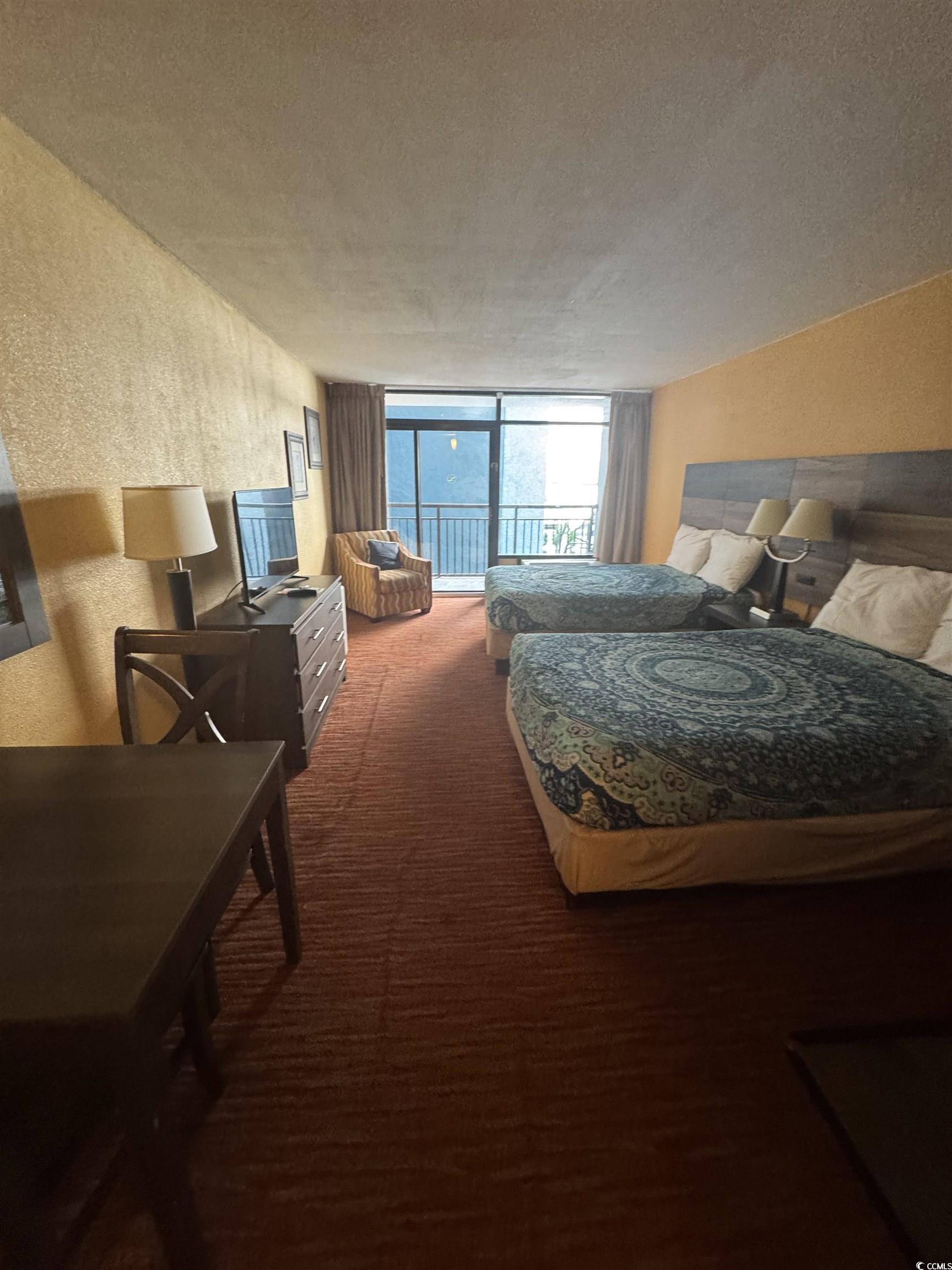 Image 2: Bedroom with a textured wall, carpet floors, acces Image 2: Bedroom with a textured wall, carpet floors, acces
