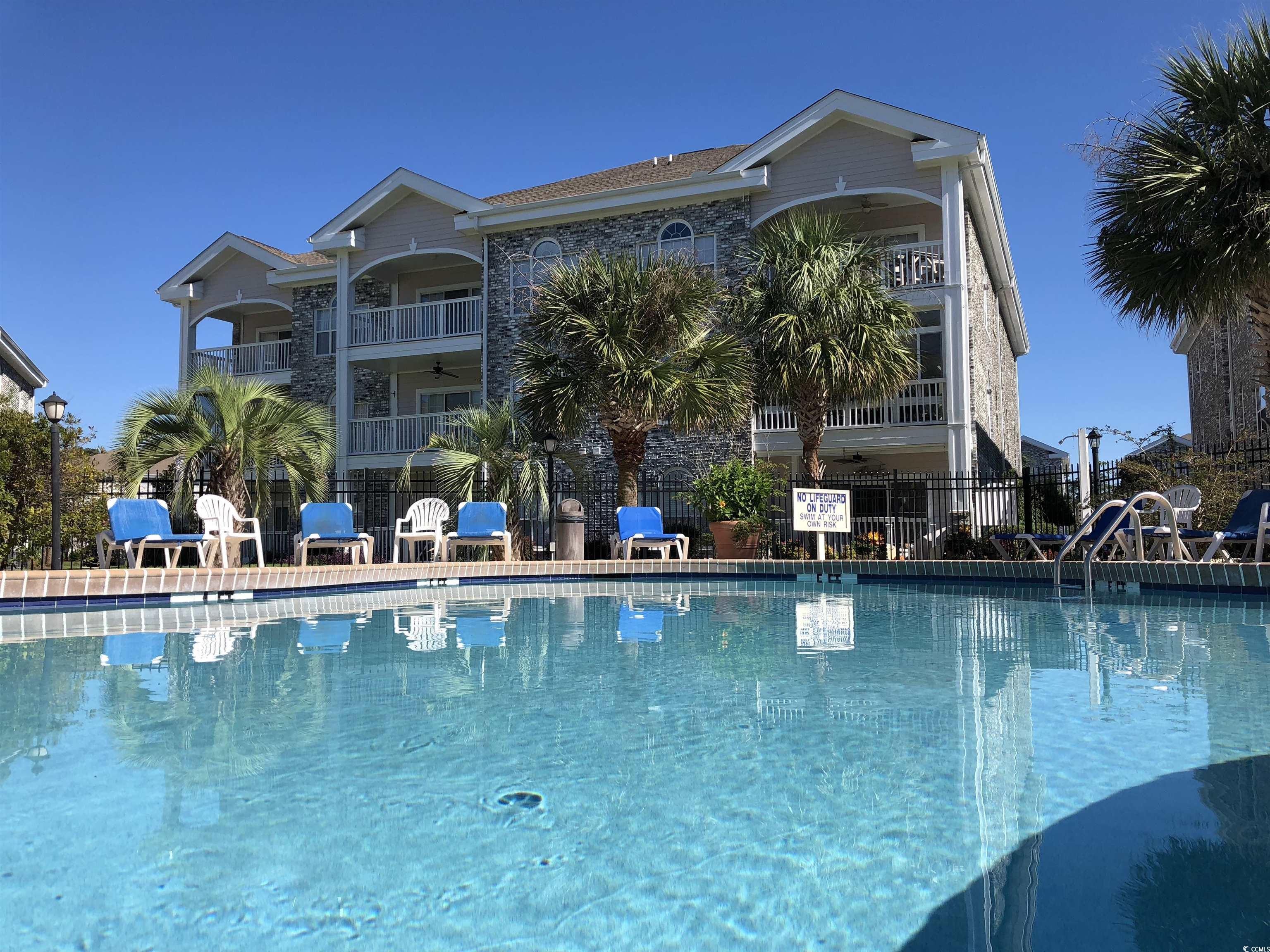Image 2: Community pool with a patio Image 2: Community pool with a patio
