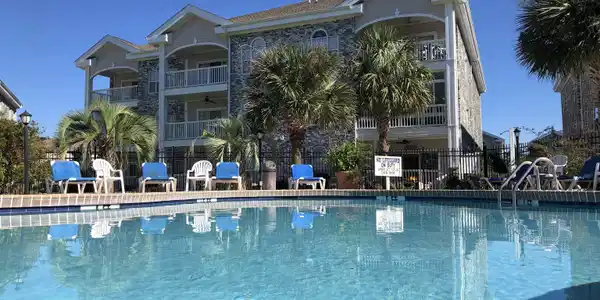 Image 2: Community pool with a patio Image 2: Community pool with a patio