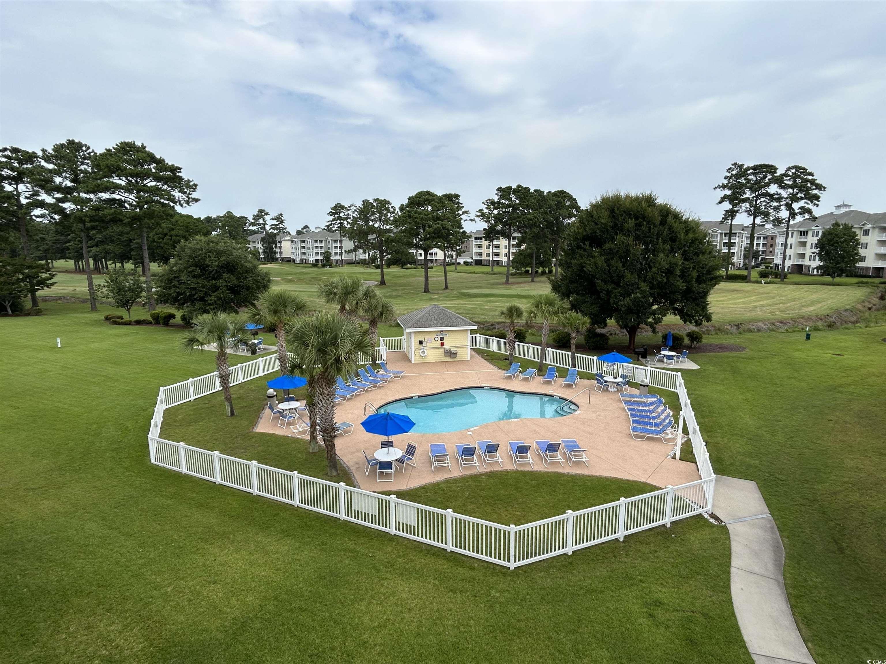 Image 4: Community pool featuring a fenced backyard and a p Image 4: Community pool featuring a fenced backyard and a p
