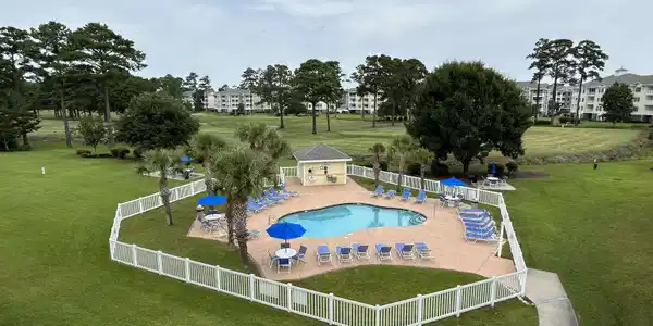Image 4: Community pool featuring a fenced backyard and a p Image 4: Community pool featuring a fenced backyard and a p