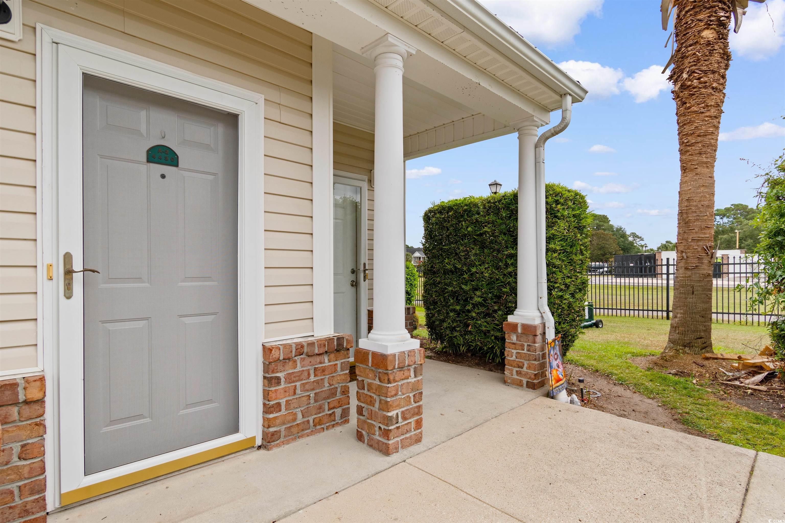 Image 3: View of exterior entry featuring covered porch and