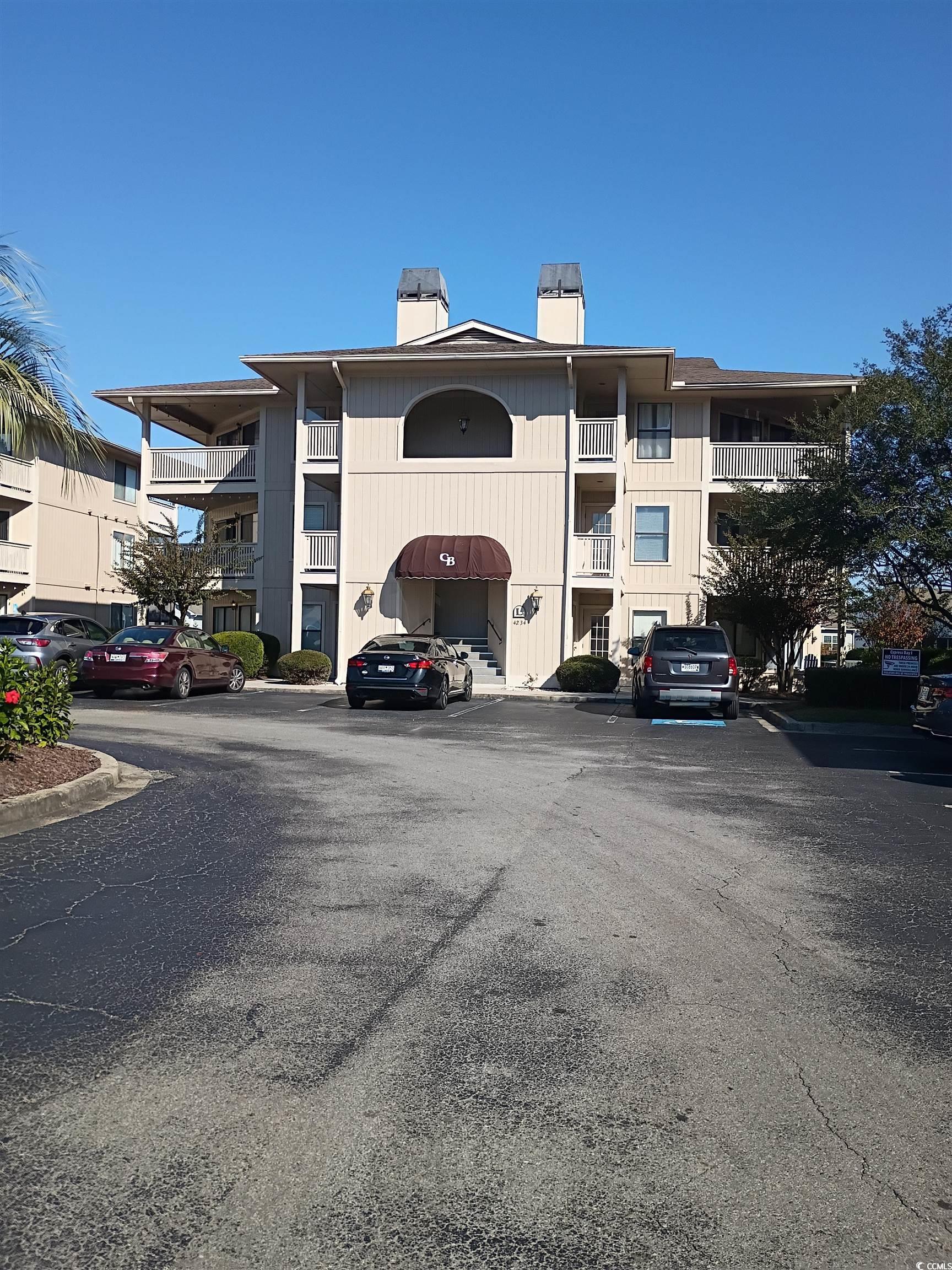 Image 1: View of property featuring uncovered parking