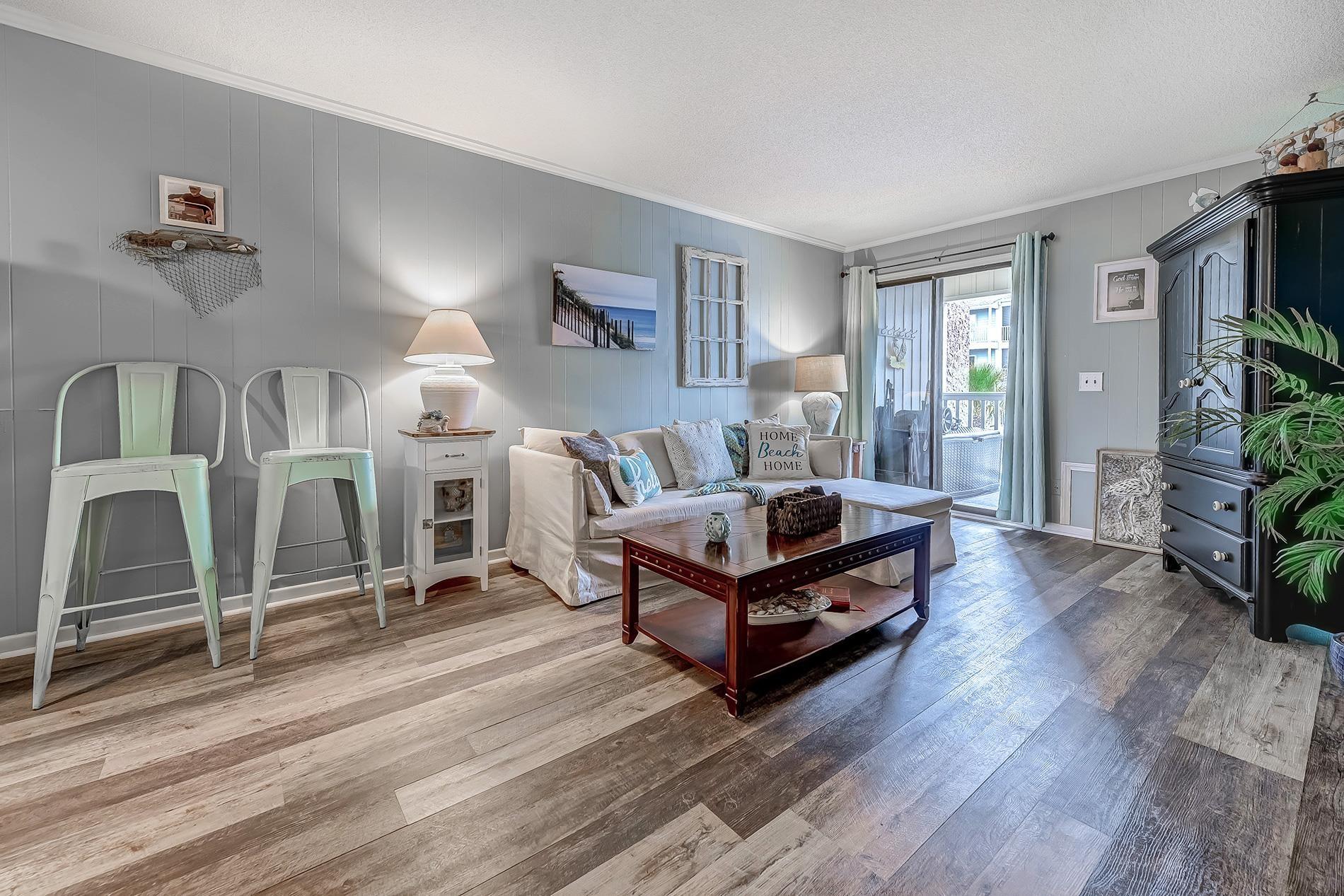 Image 4: Living room featuring ornamental molding, hardwood